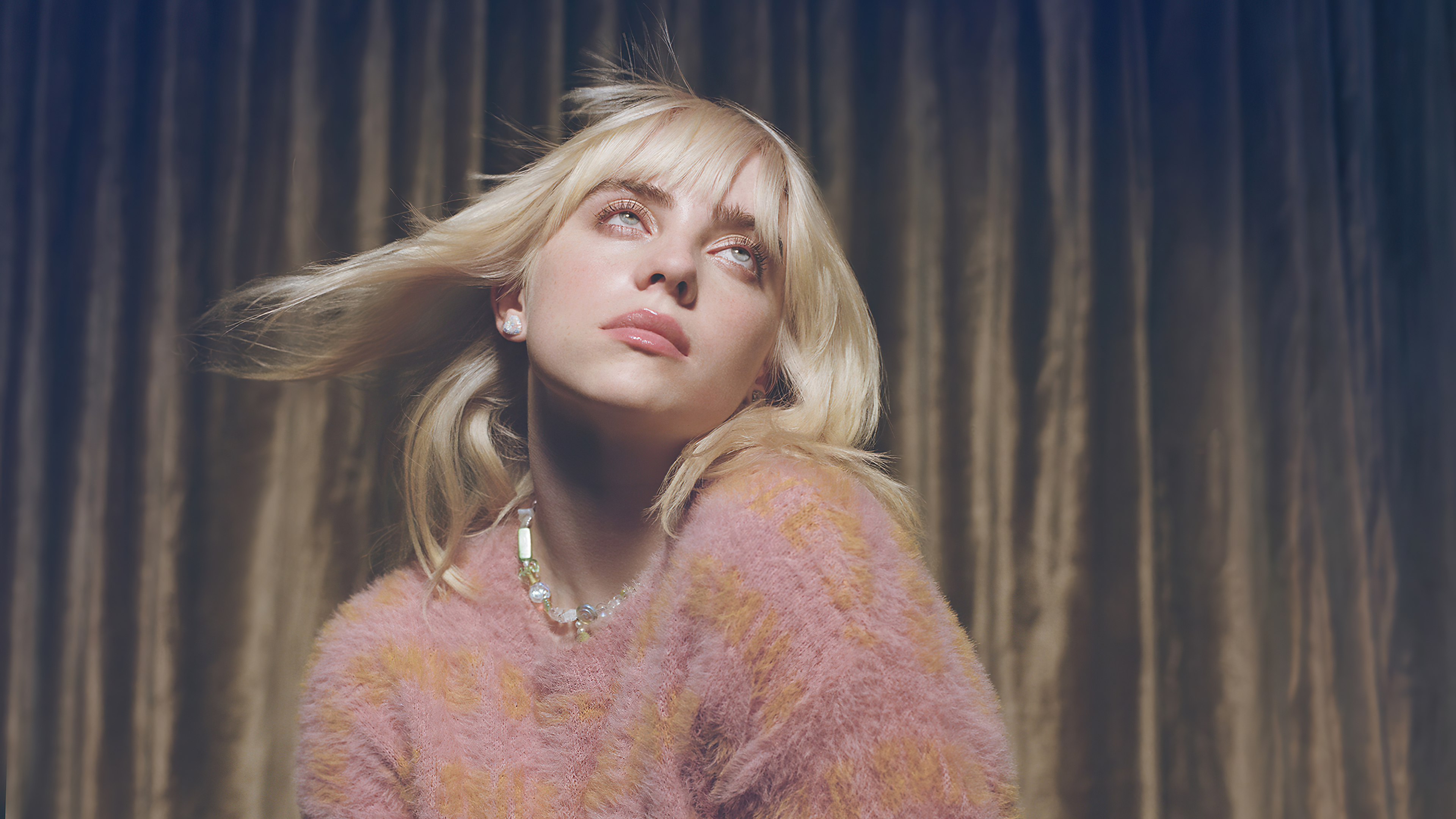 Billie Eilish in pink fuzzy sweater looking up 4K HD Wallpaper