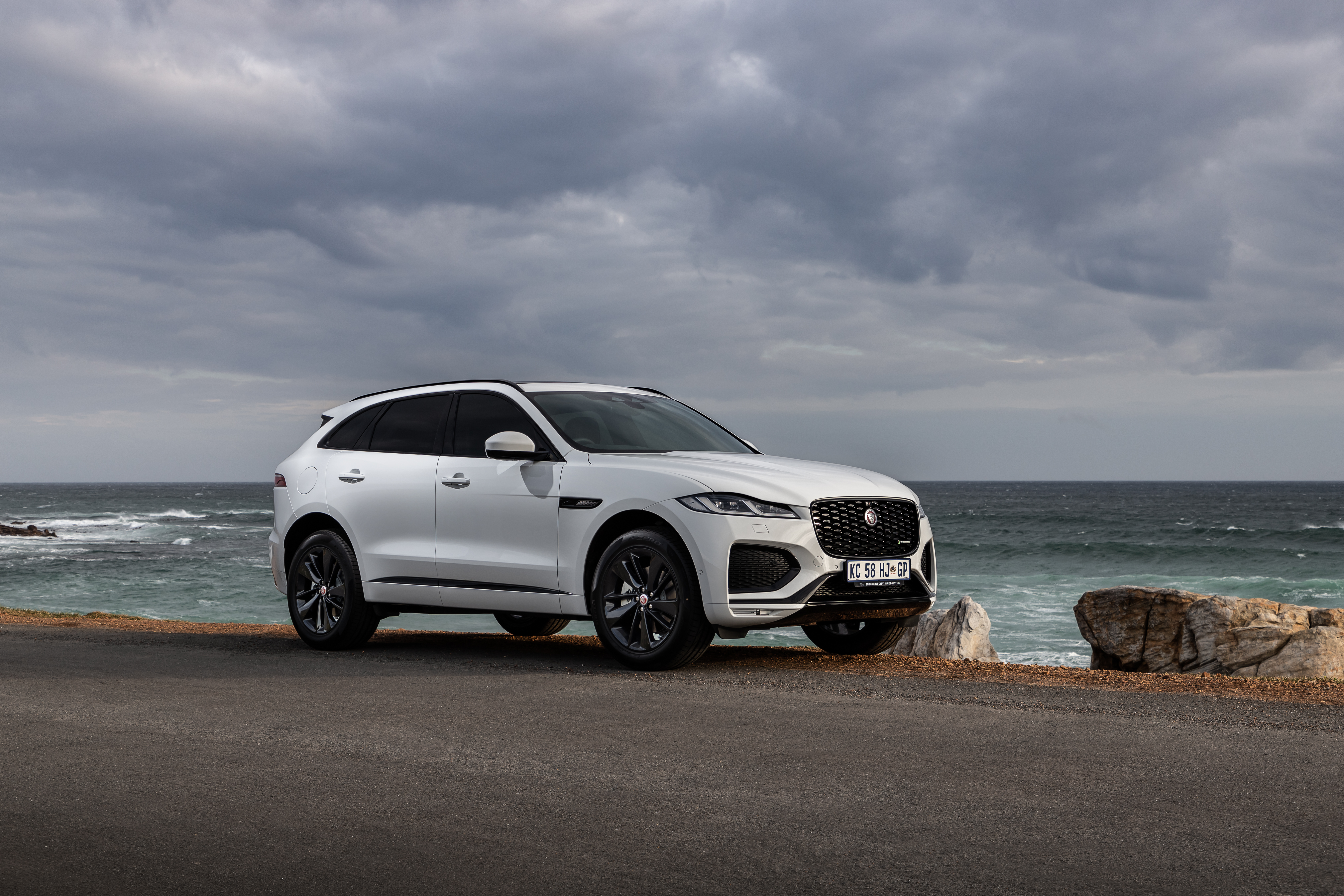 White Jaguar F-Pace SUV parked by the ocean HD Wallpaper