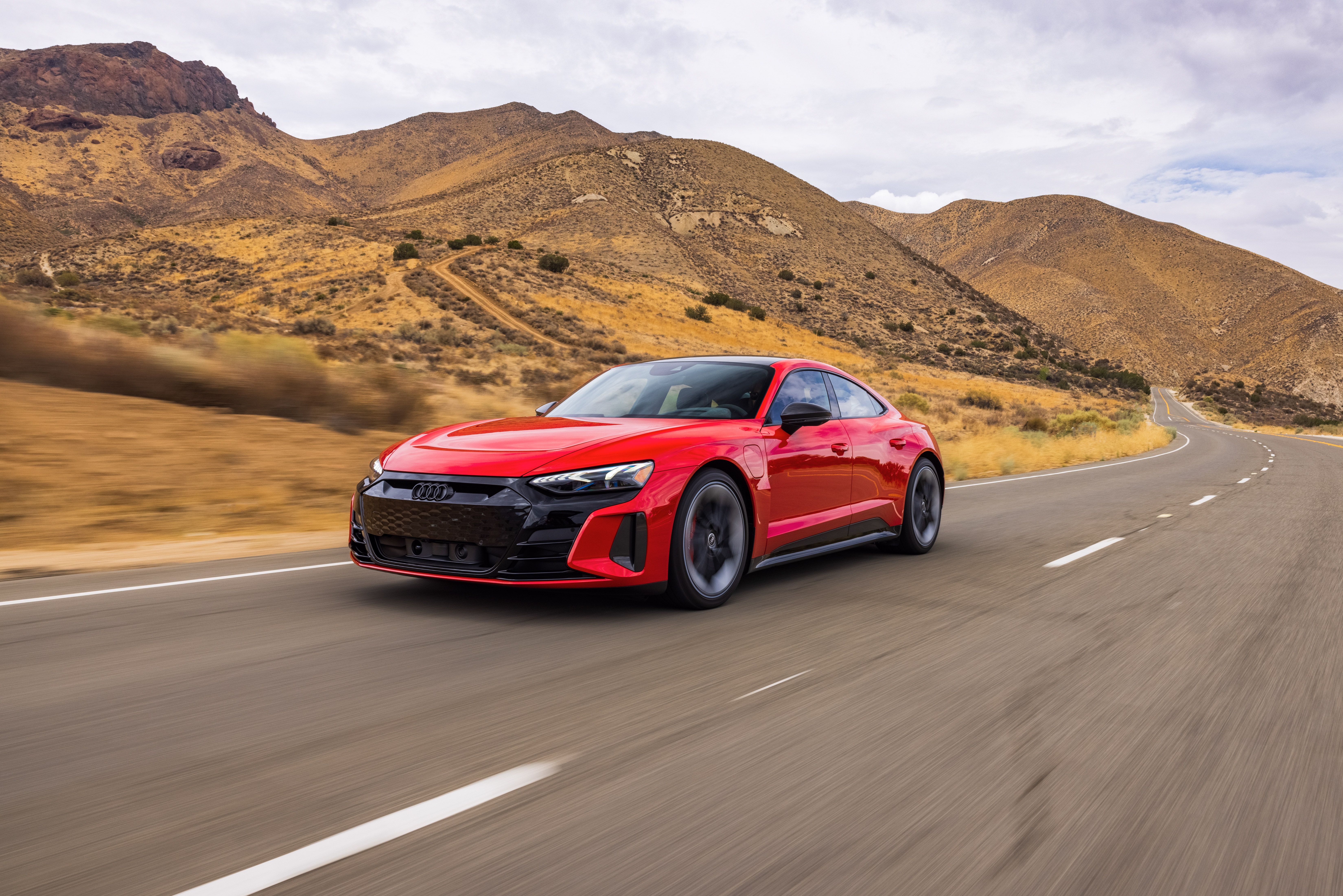 Red Audi RS e-tron GT electric sport car on desert road HD Wallpaper