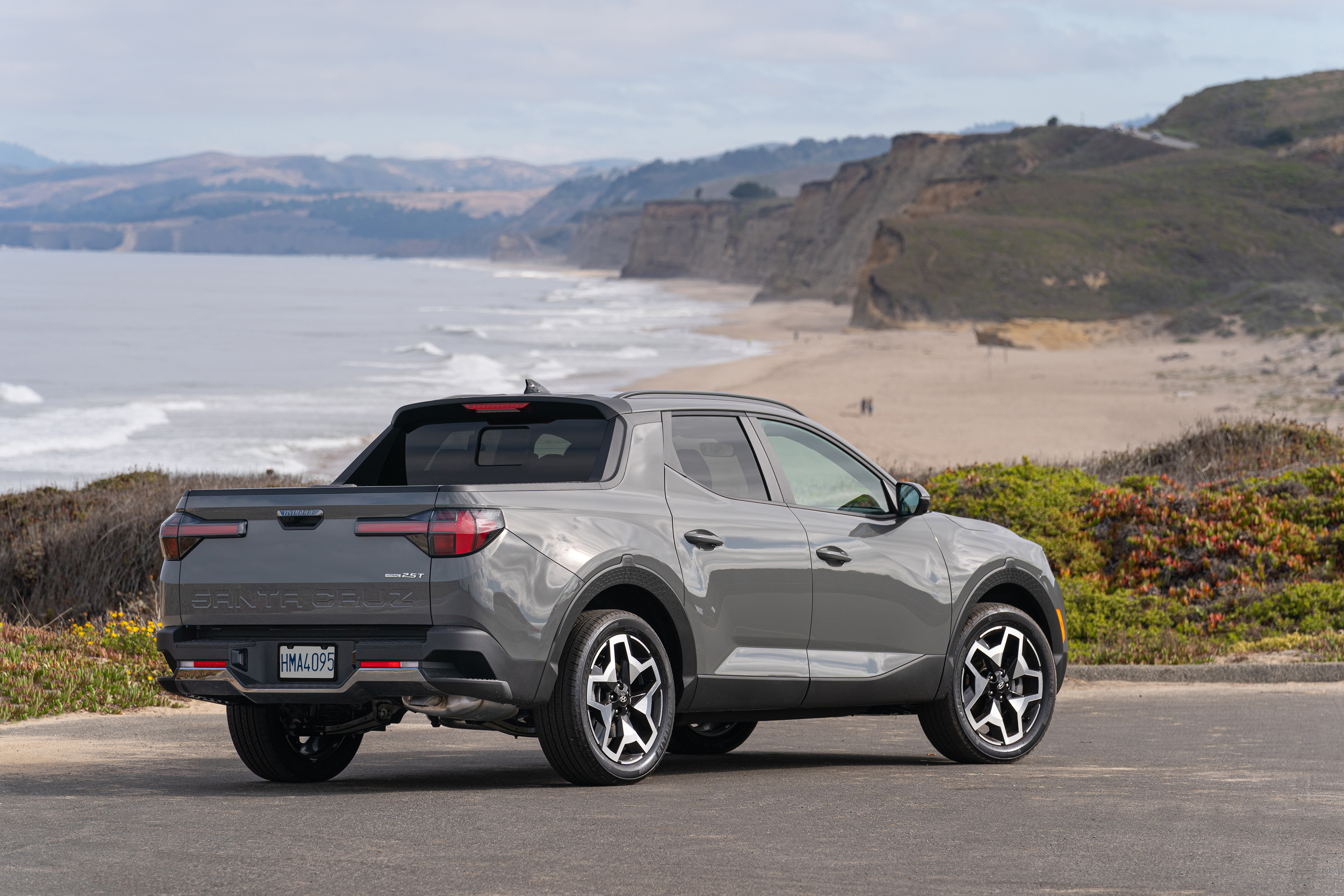 Hyundai Santa Cruz pickup overlooking a scenic beach HD Wallpaper