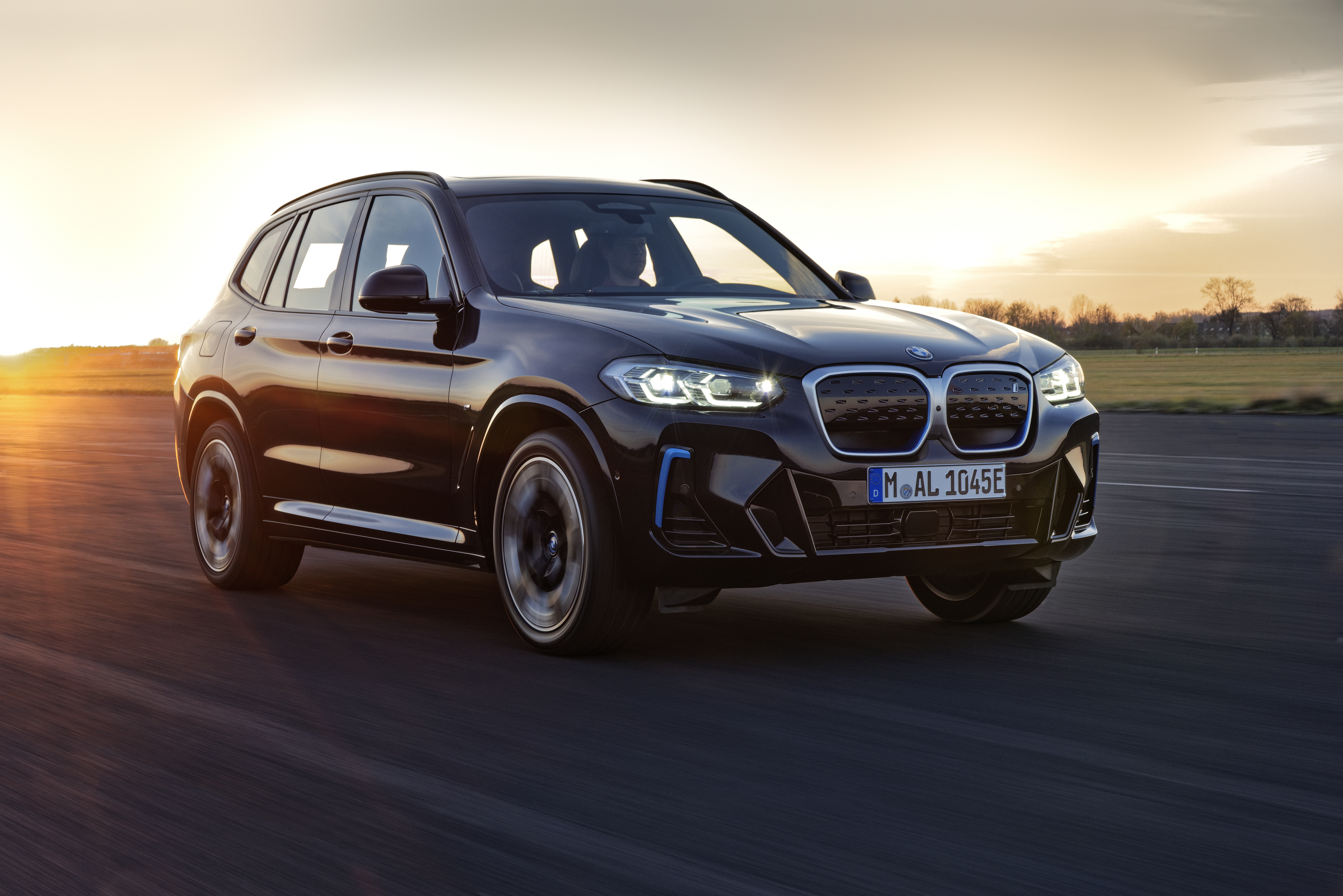 Black BMW iX3 M Sport Electric SUV at sunset HD Wallpaper