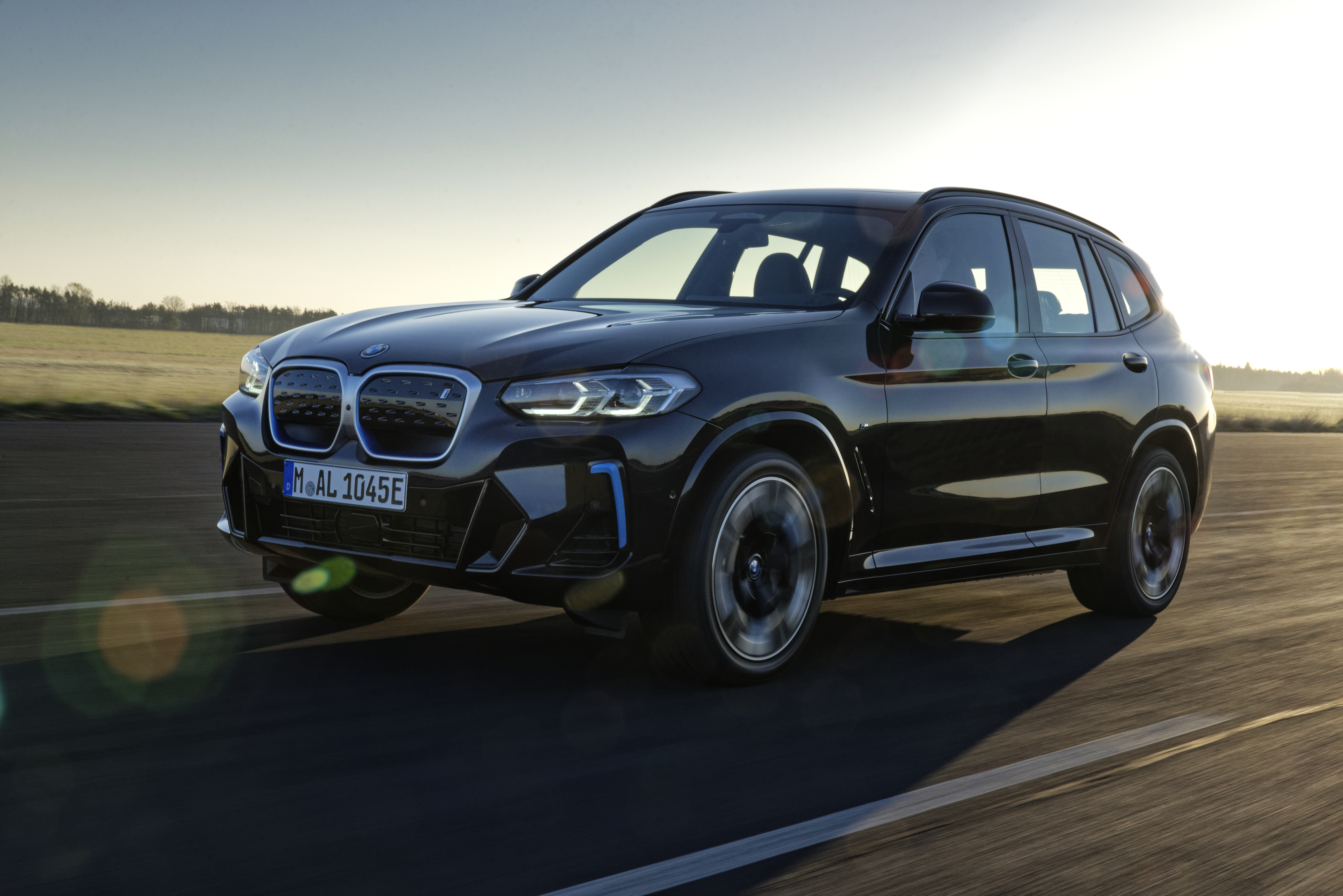 Black BMW iX3 M Sport Electric SUV driving HD Wallpaper