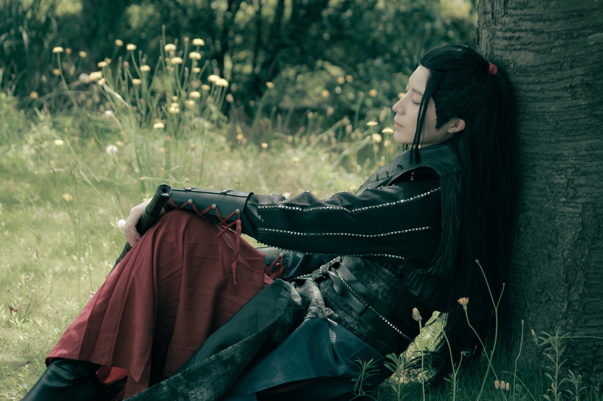 Wei Wuxian resting peacefully in a grassy field HD Wallpaper