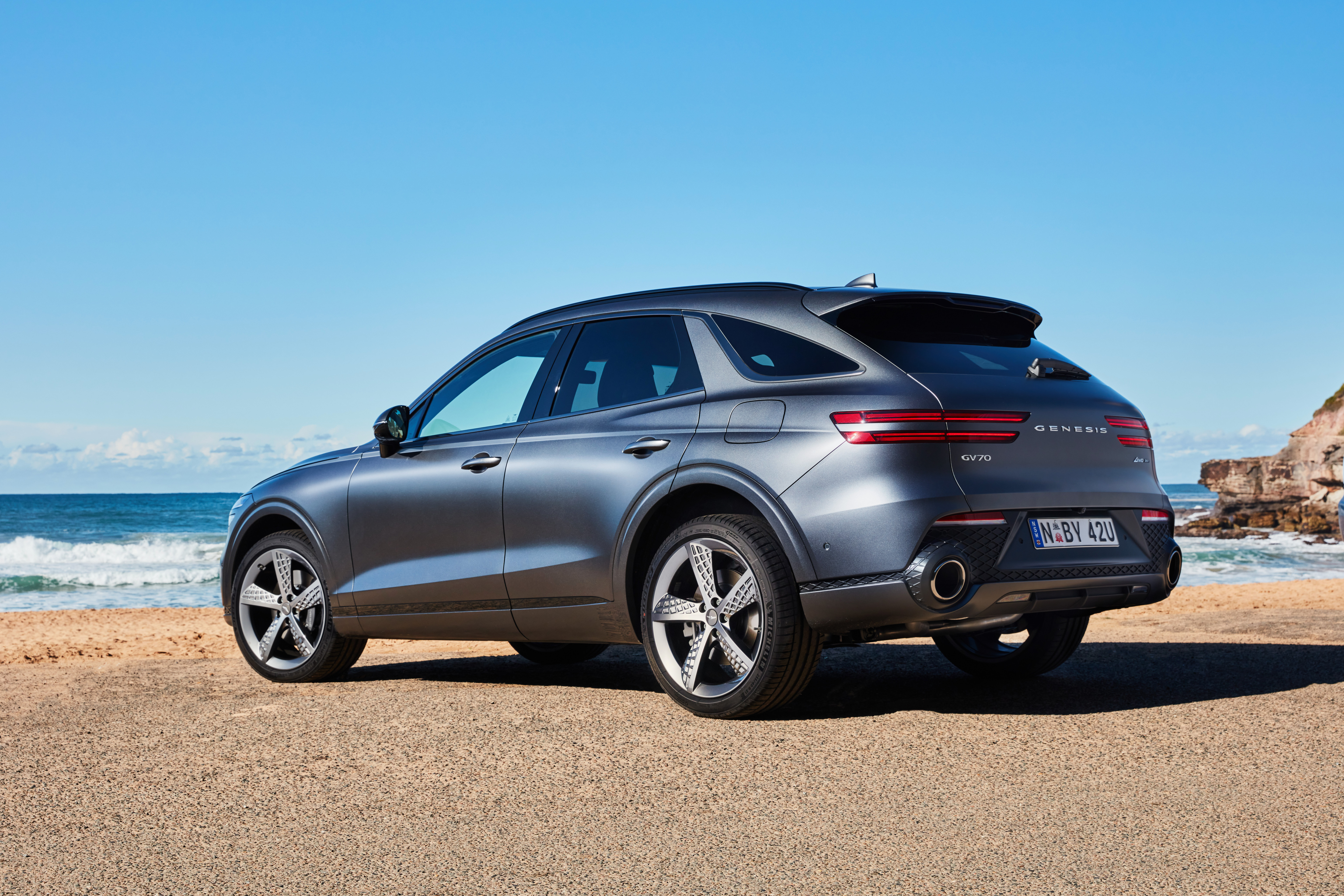 Grey Genesis GV70 SUV parked on a beach HD Wallpaper