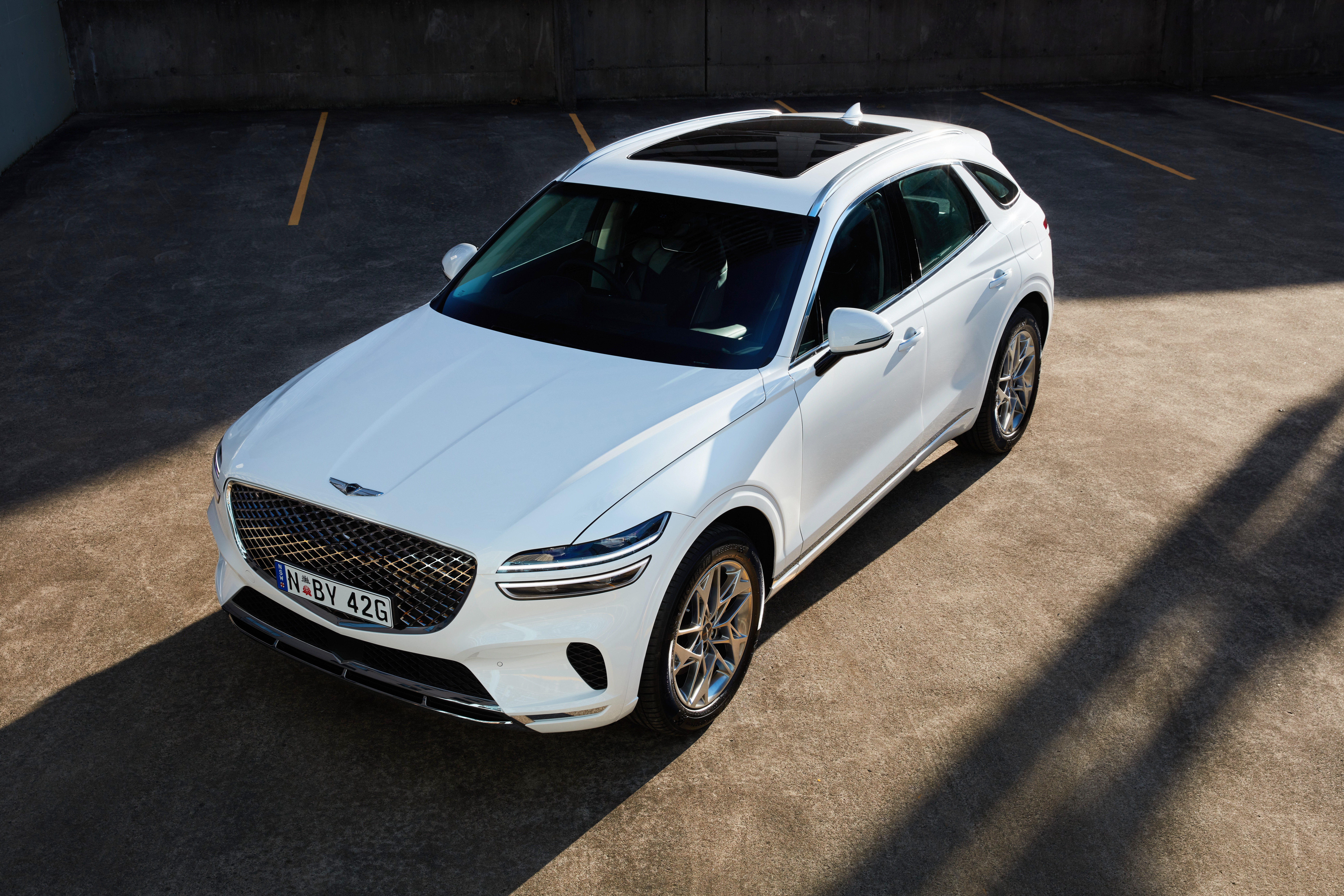 White Genesis GV70 2.5T SUV parked from above HD Wallpaper