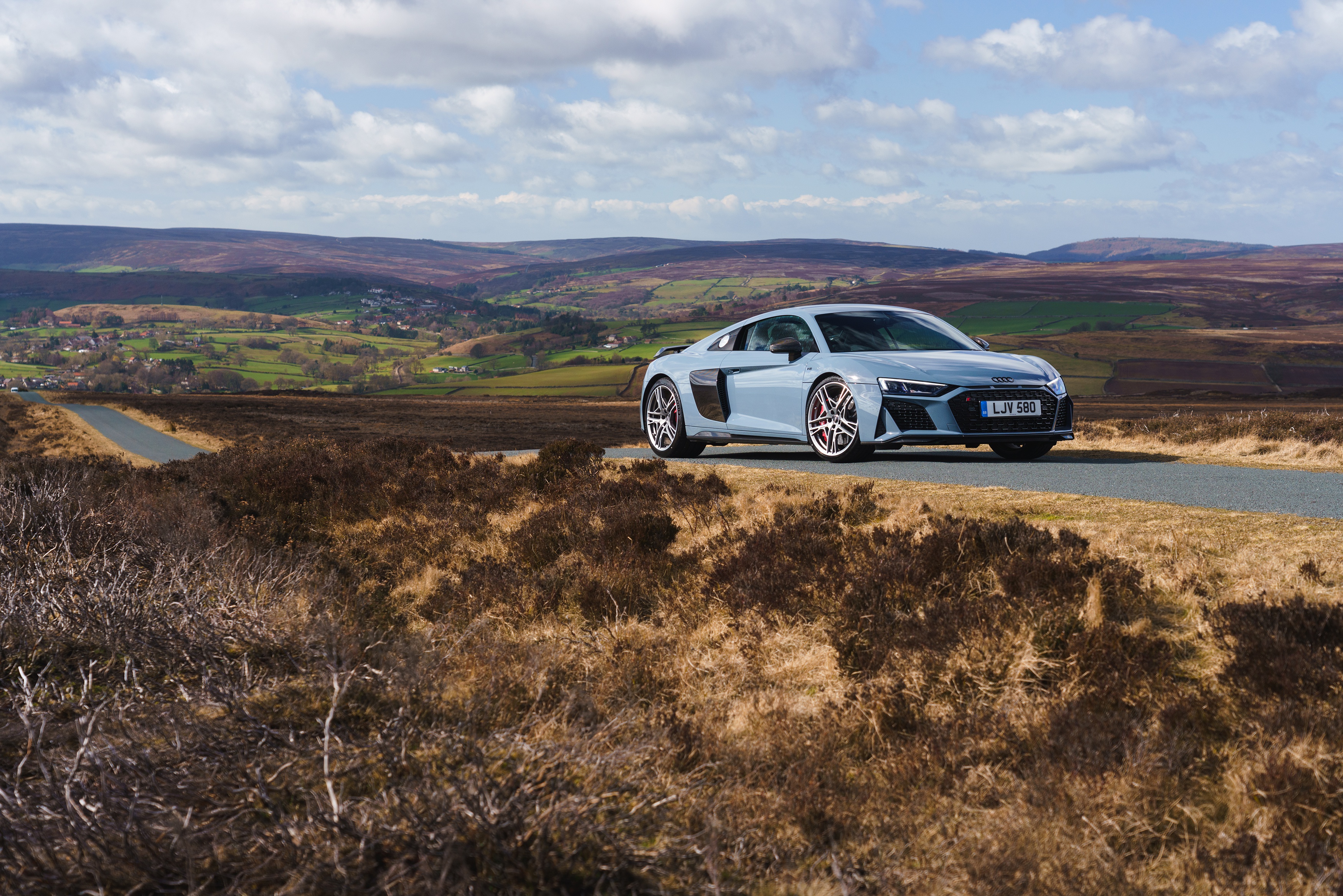 Audi R8 V10 sport car on a scenic road HD Wallpaper