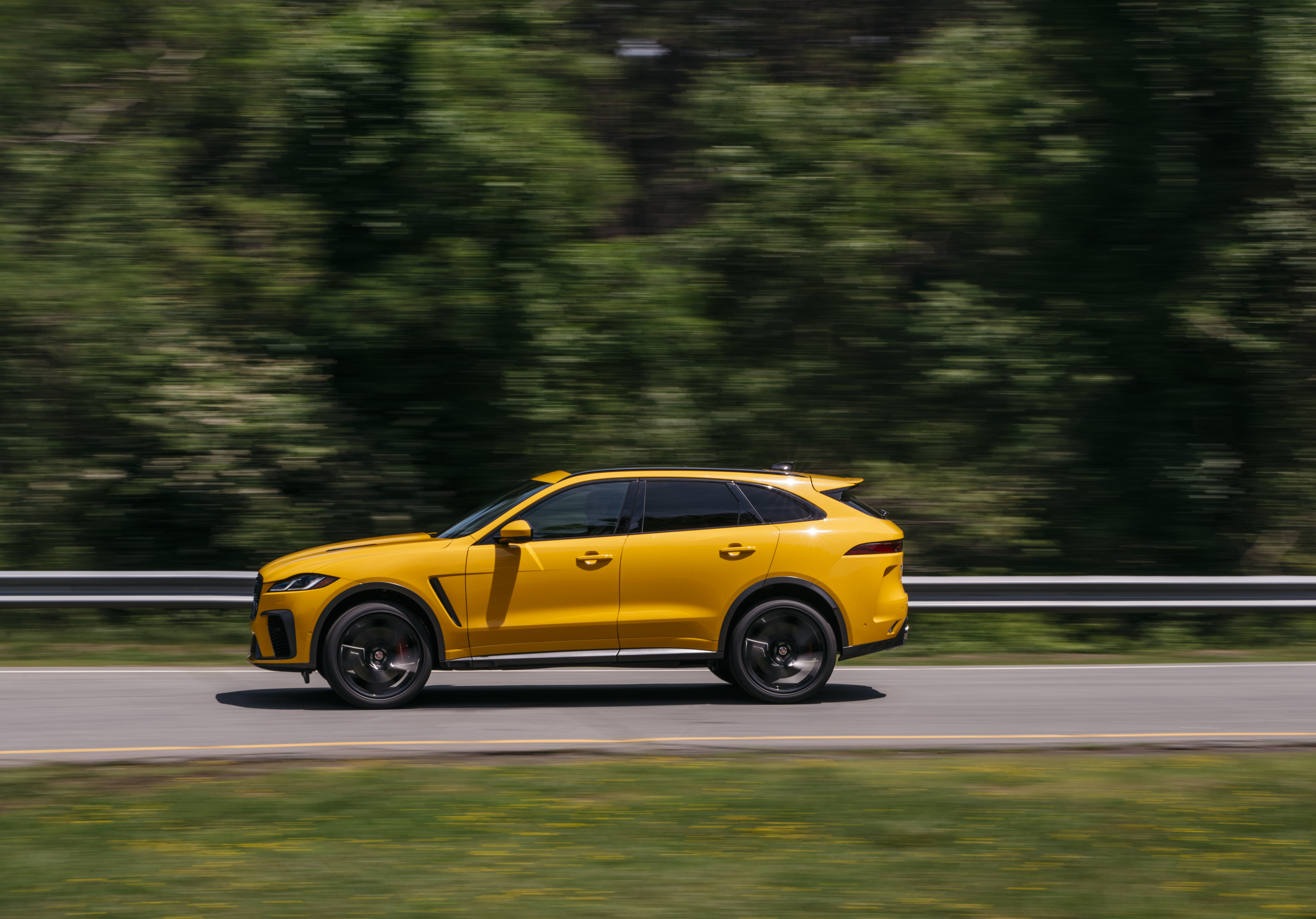 Yellow Jaguar F-Pace SVR SUV speeding on road HD Wallpaper