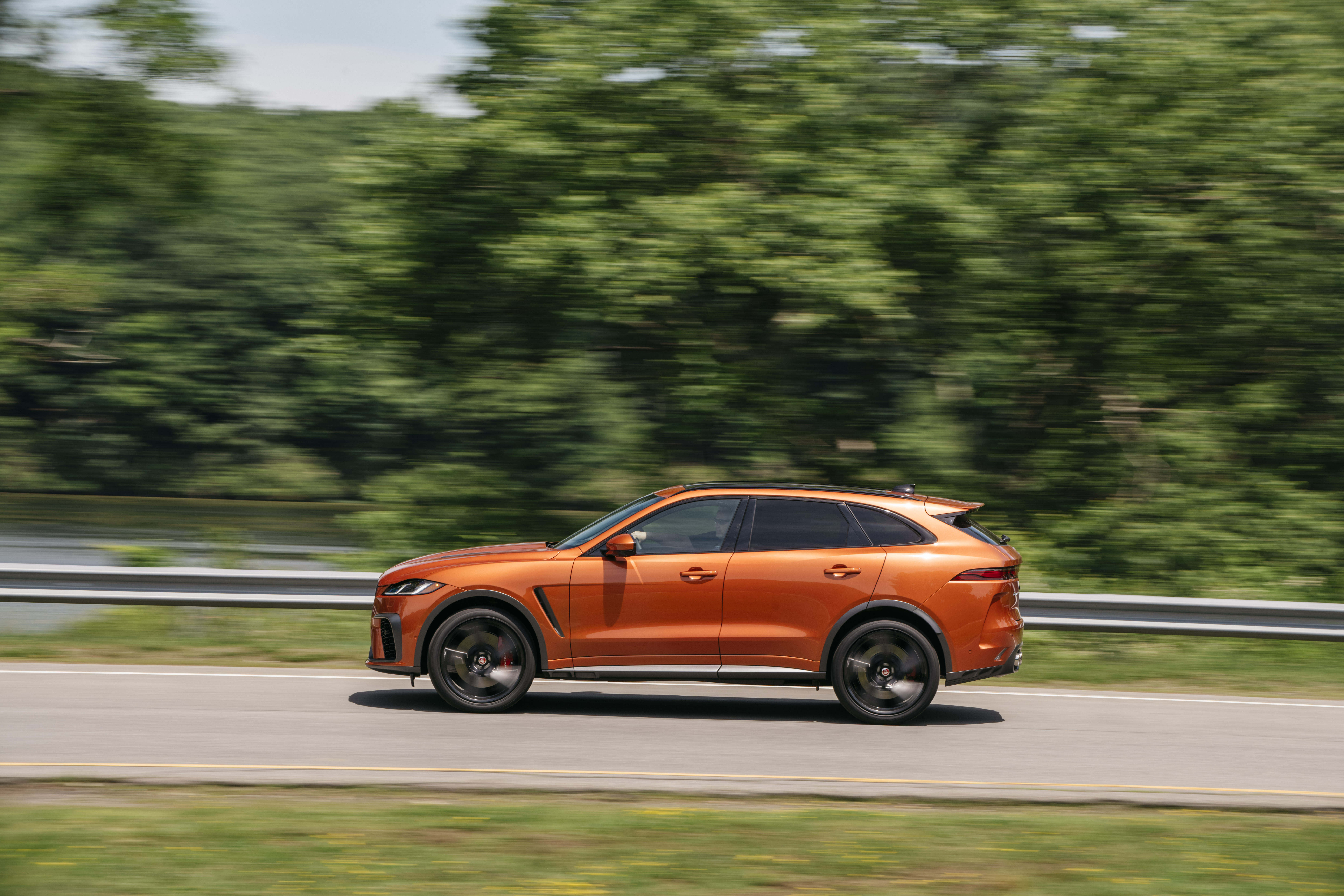 Orange Jaguar F-Pace SVR SUV in motion HD Wallpaper