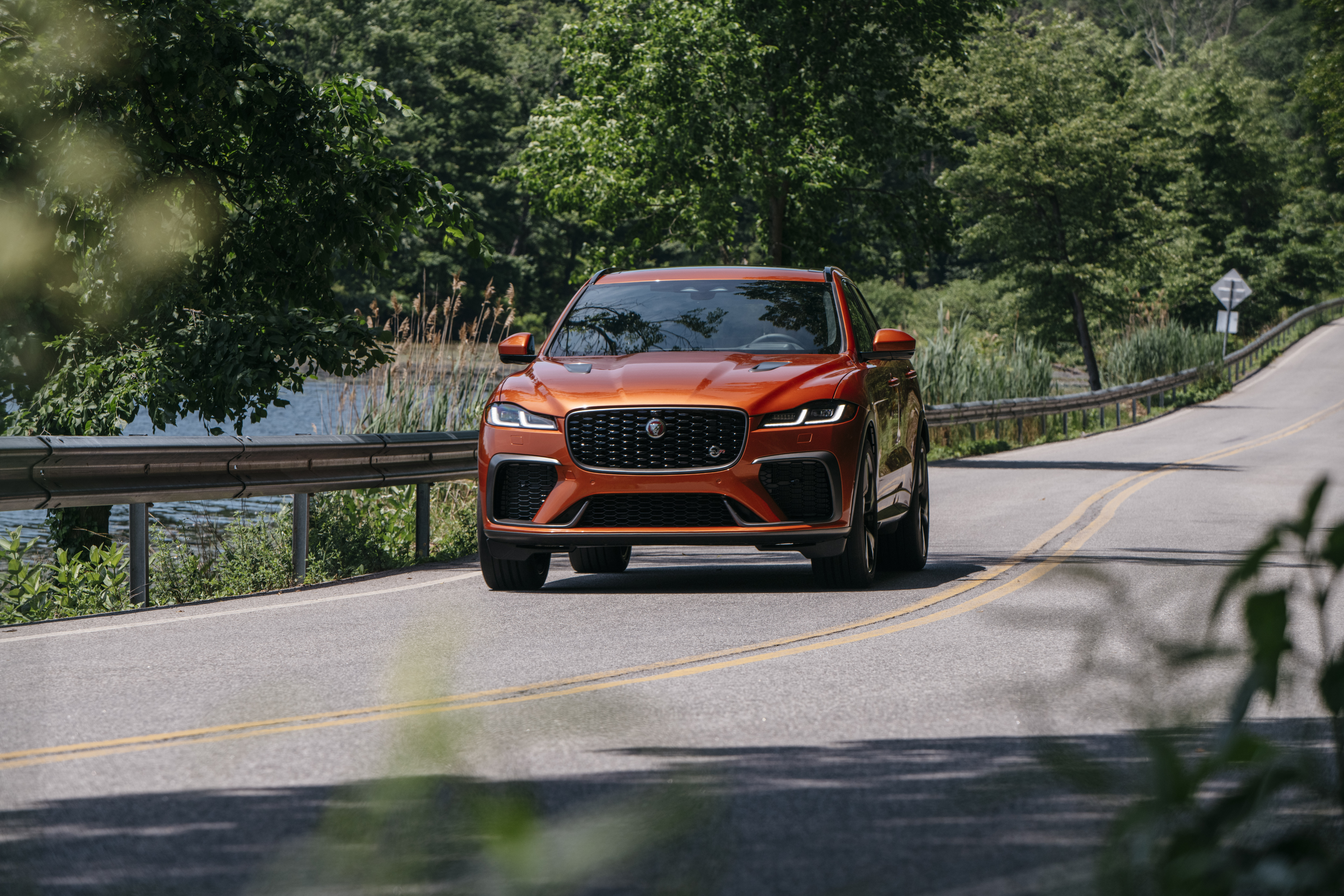 Orange Jaguar F-Pace SVR SUV on a scenic road HD Wallpaper