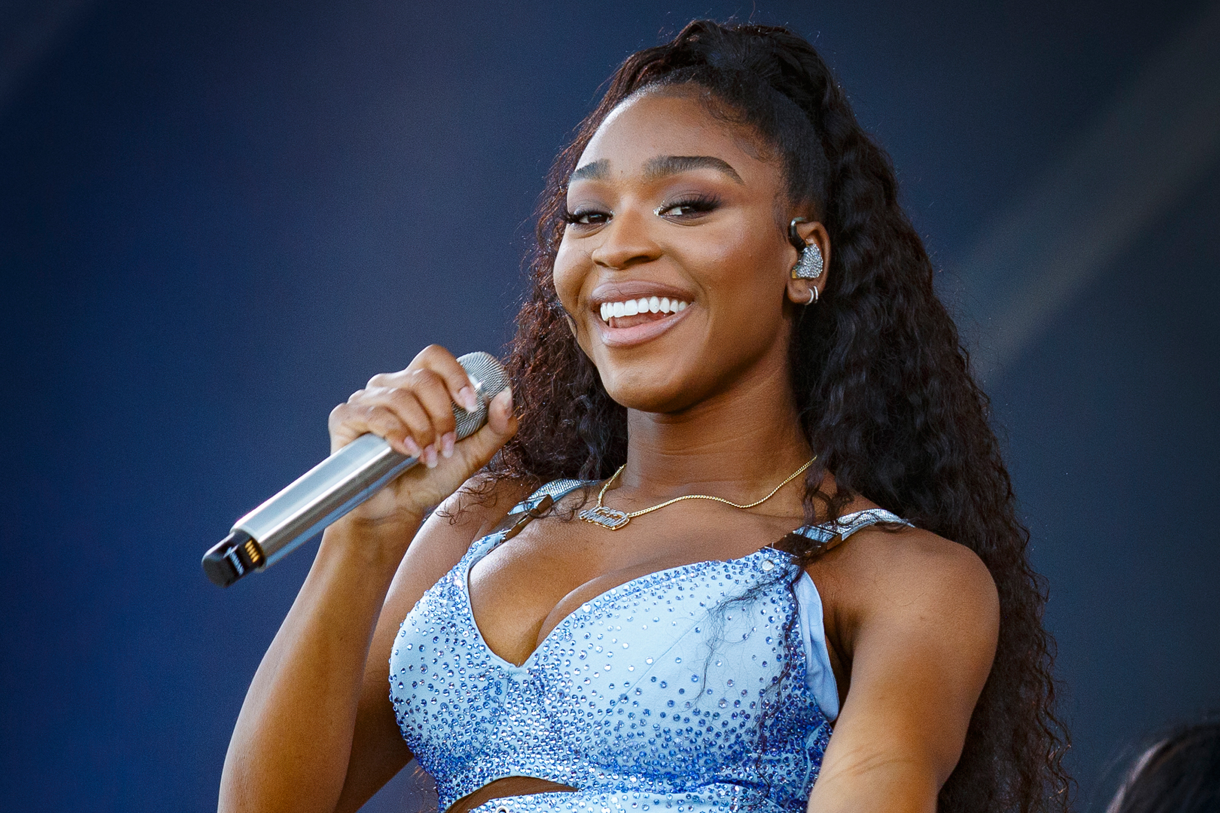 Normani smiling and singing on stage HD Wallpaper