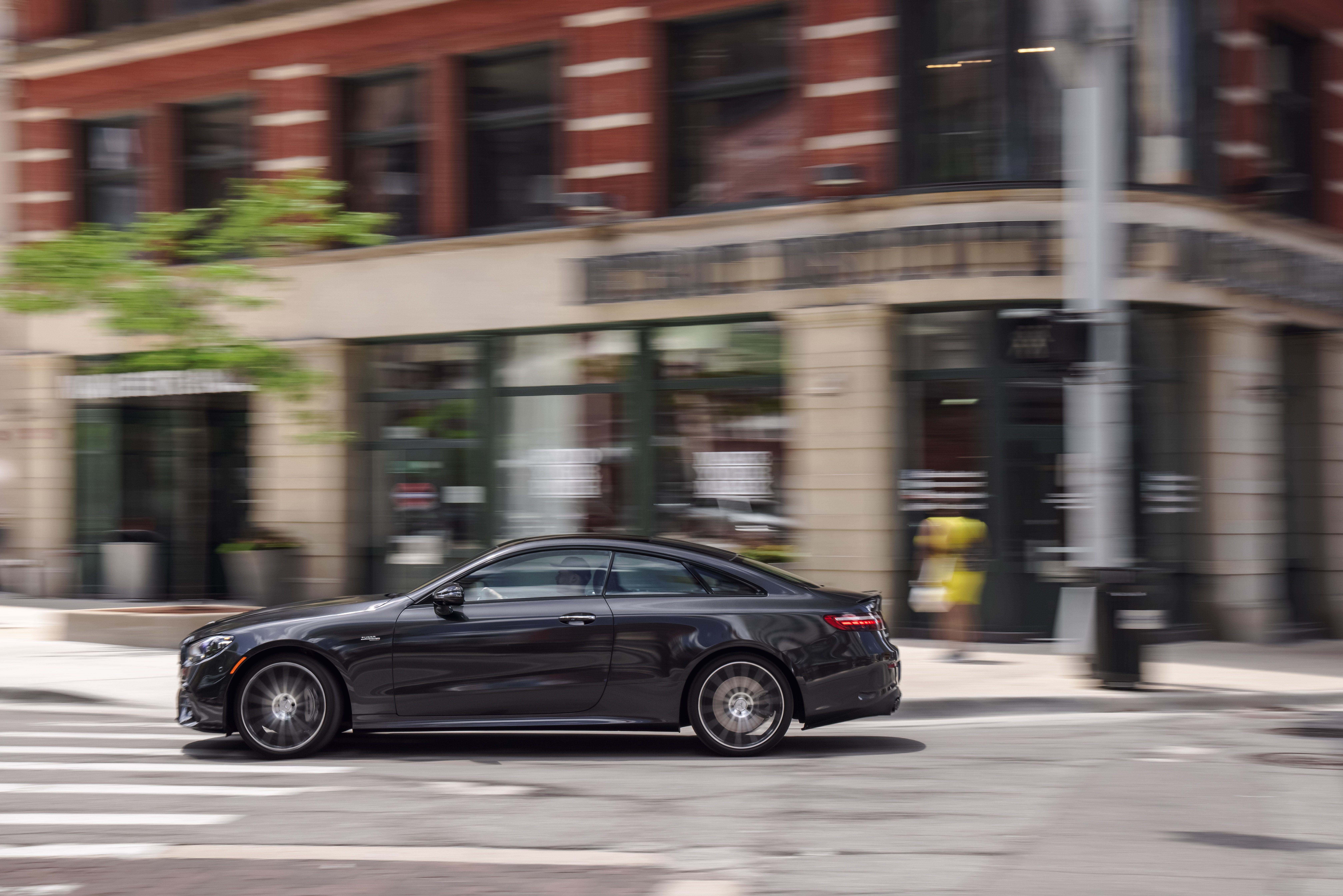 Luxury Mercedes-AMG E 53 Coupe in motion on city street HD Wallpaper