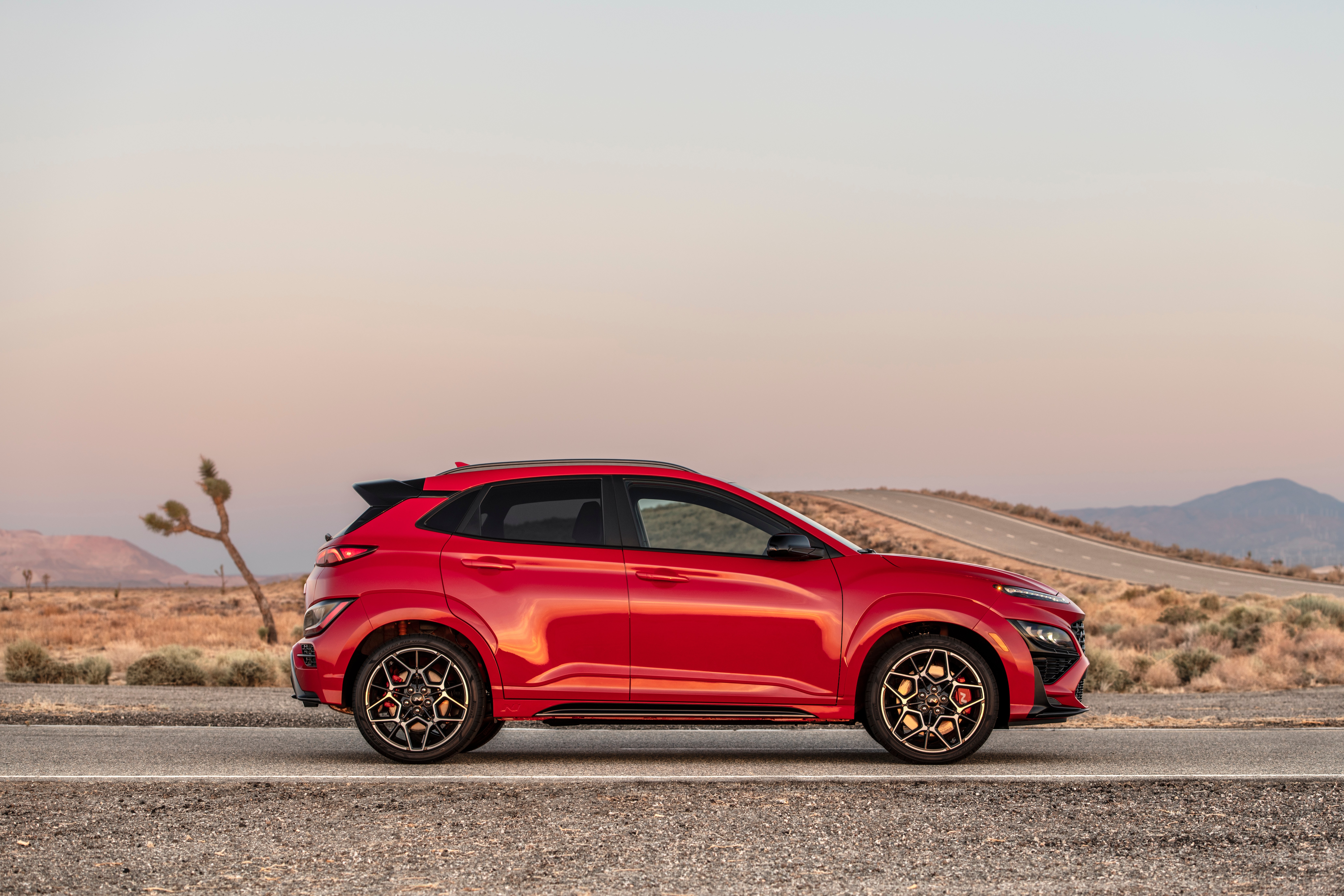 Red 2022 Hyundai Kona N SUV in desert landscape HD Wallpaper