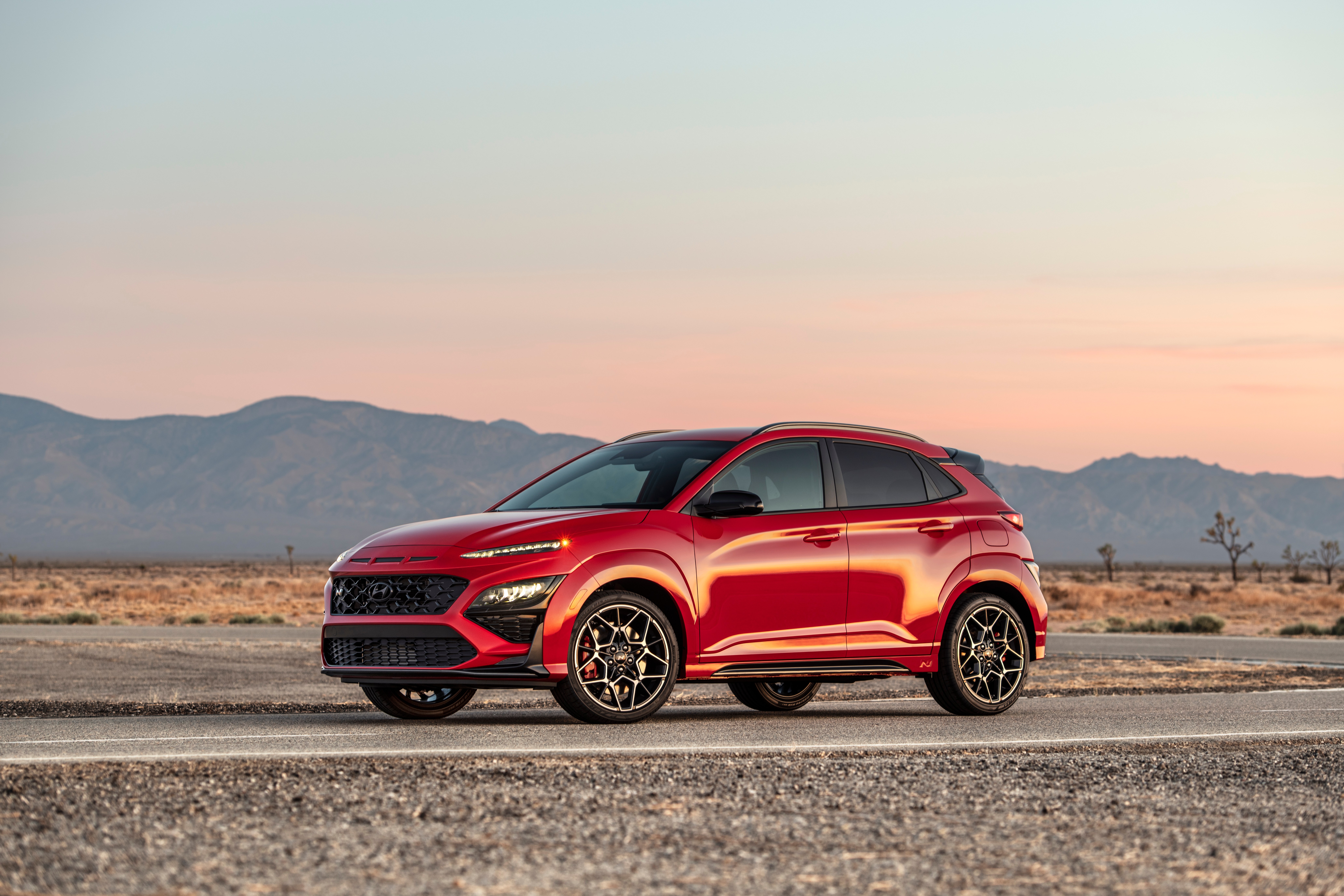 Red 2022 Hyundai Kona N SUV in desert sunset HD Wallpaper