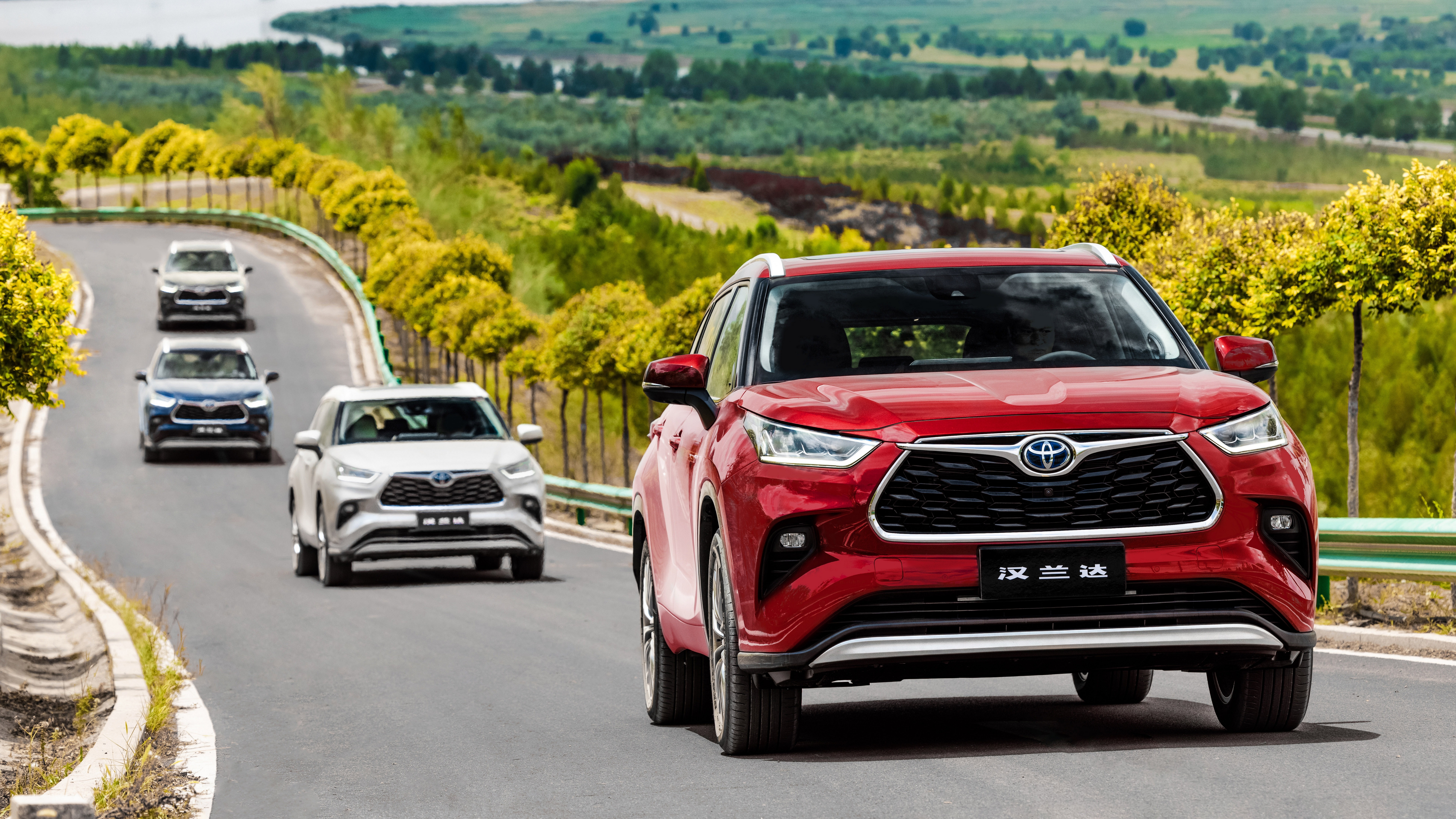 Red Toyota Highlander Hybrid leads SUVs on winding road HD Wallpaper