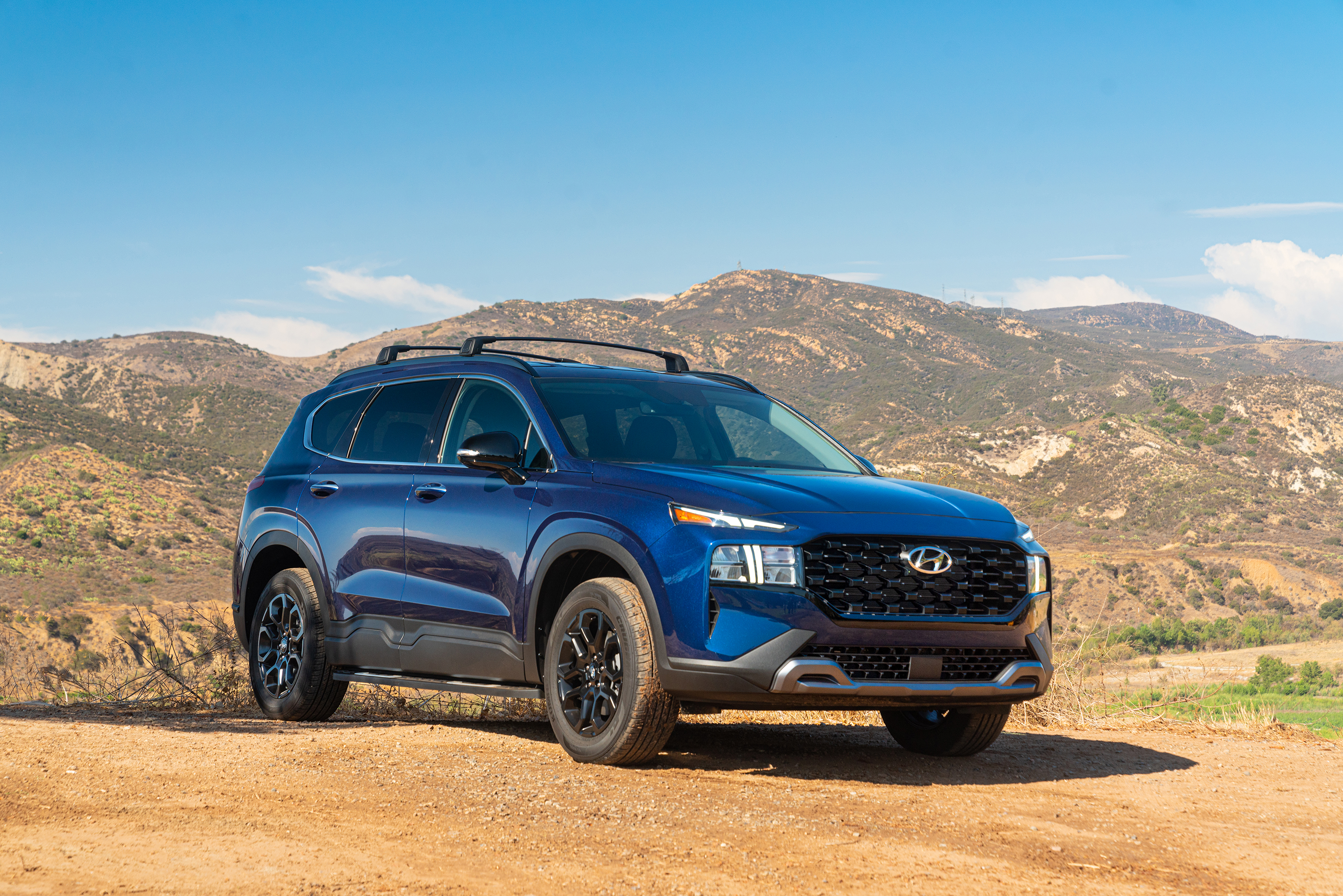 Blue 2022 Hyundai Santa Fe XRT SUV on dirt road HD Wallpaper