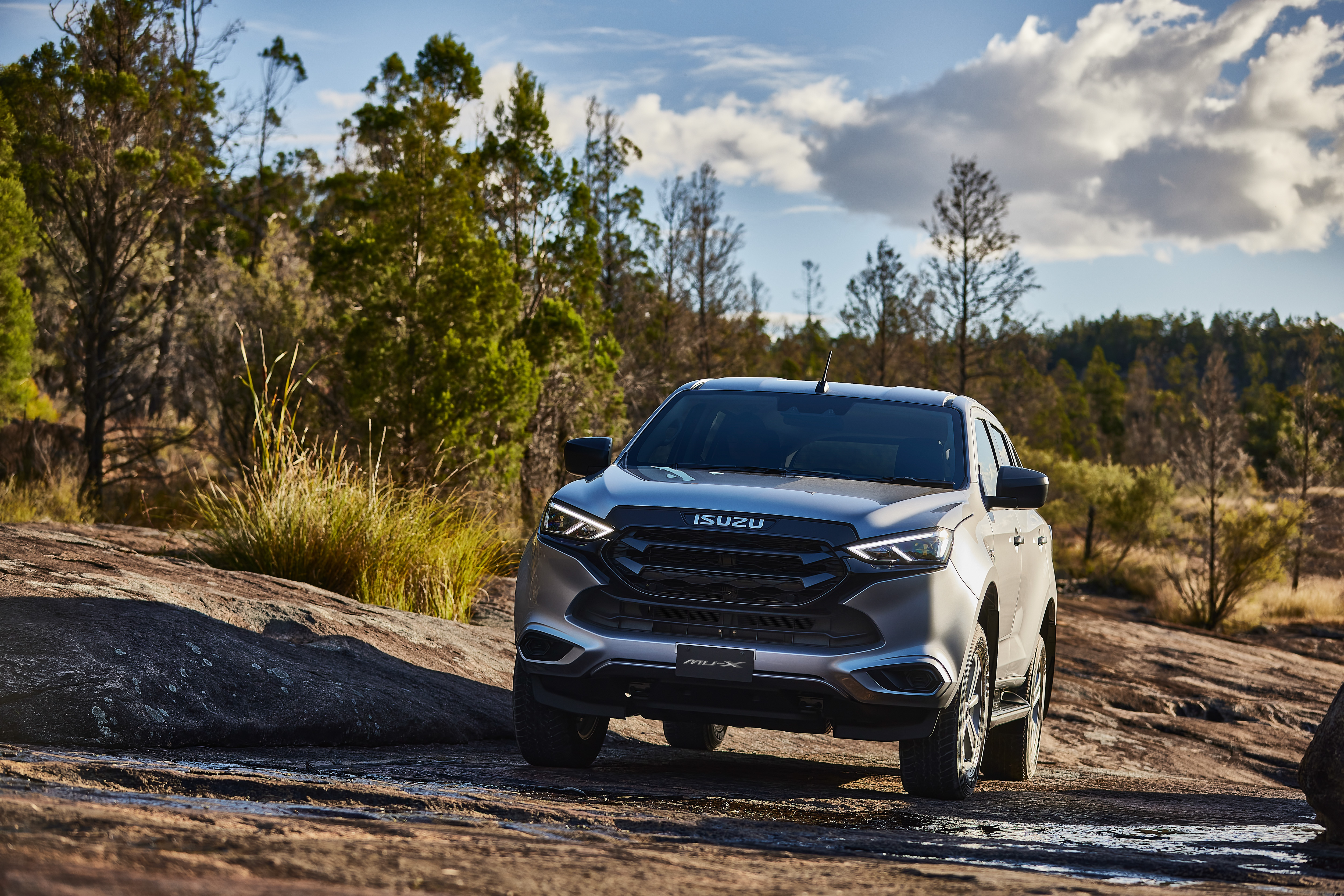 Isuzu MU-X SUV on a rocky off-road path HD Wallpaper