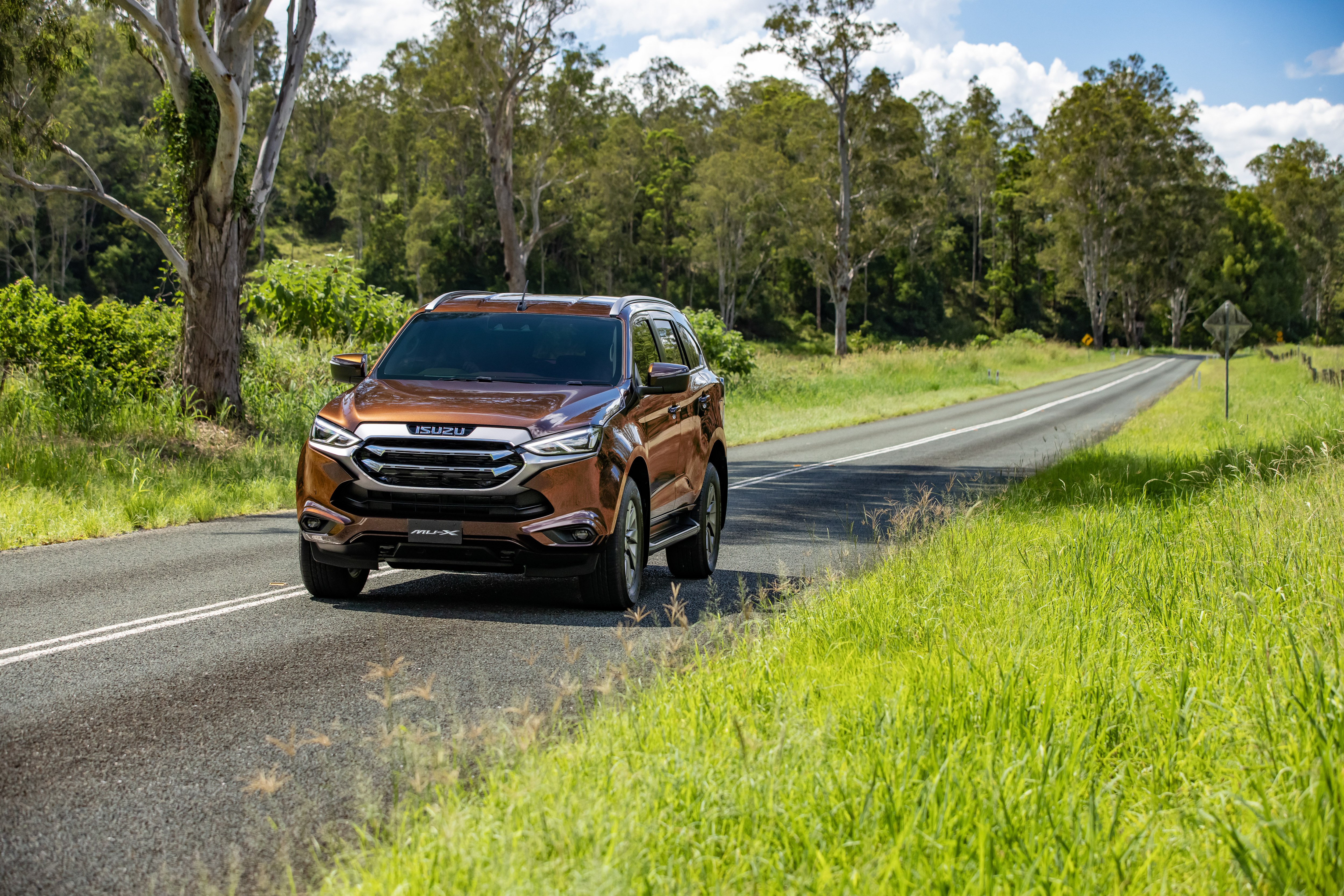 Isuzu MU-X 4x4 LS-U SUV driving on a scenic road HD Wallpaper
