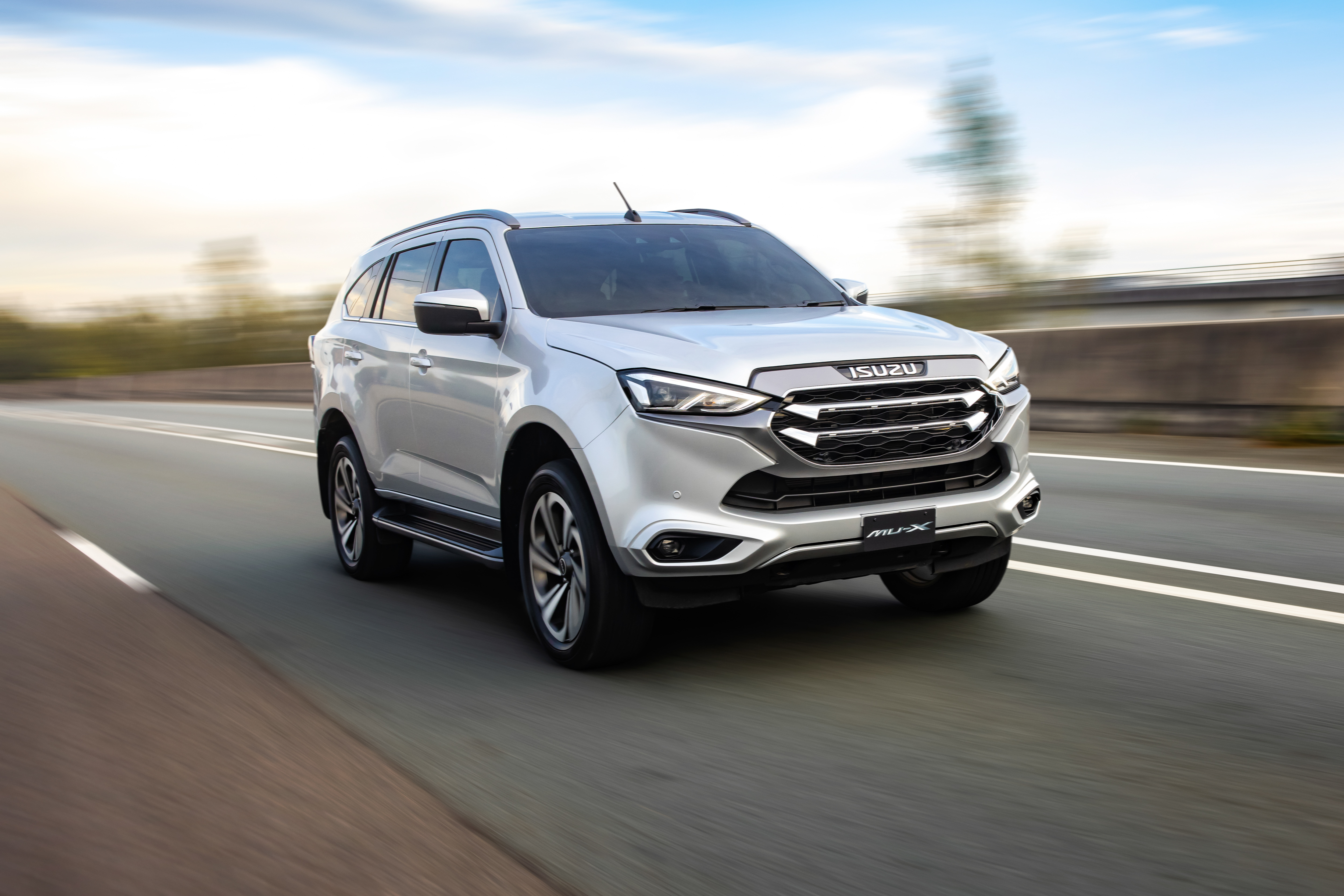 Isuzu MU-X 4x4 LS-T SUV driving on highway HD Wallpaper