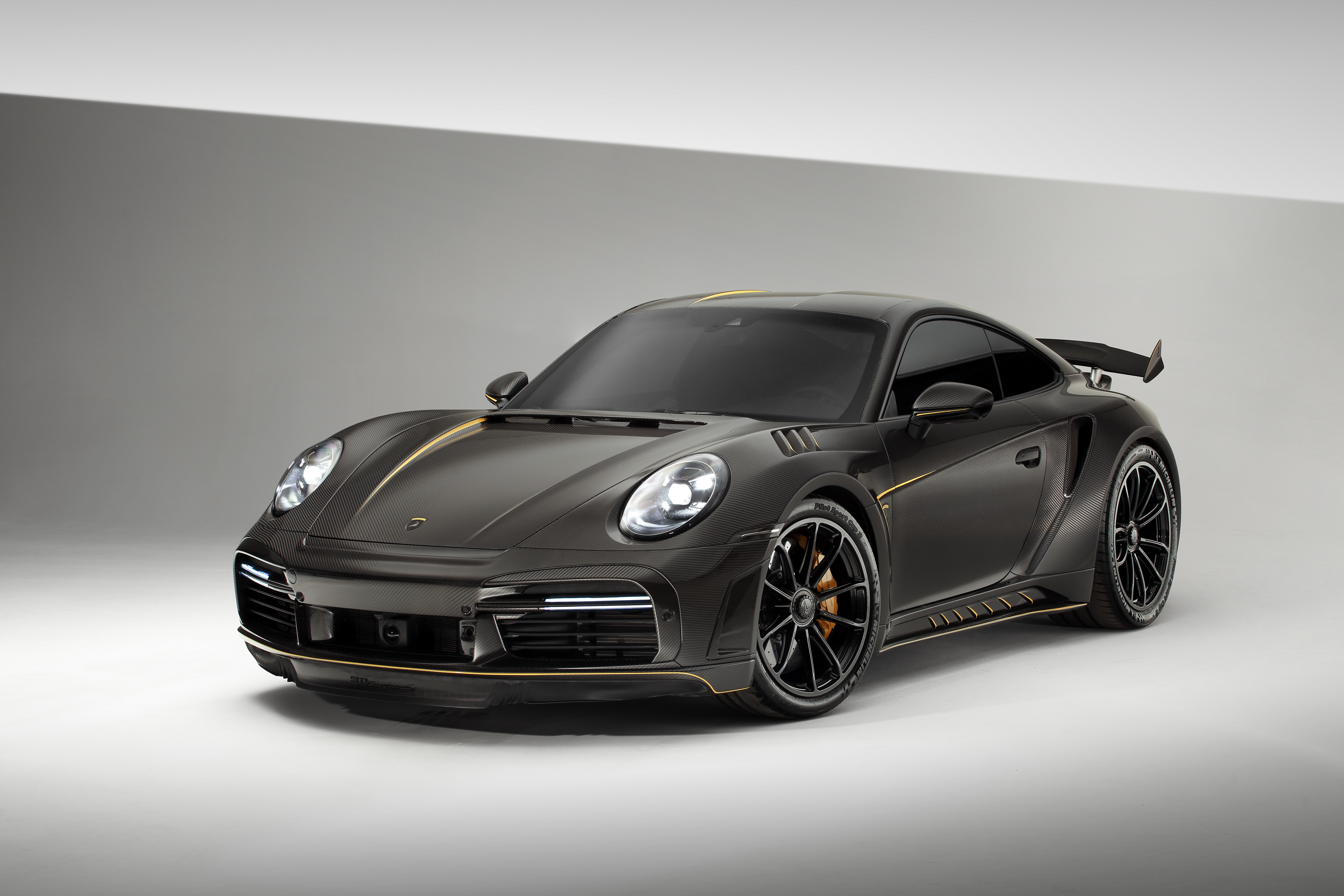 Porsche 911 Turbo S Stinger GTR Carbon Edition with gold accents HD Wallpaper