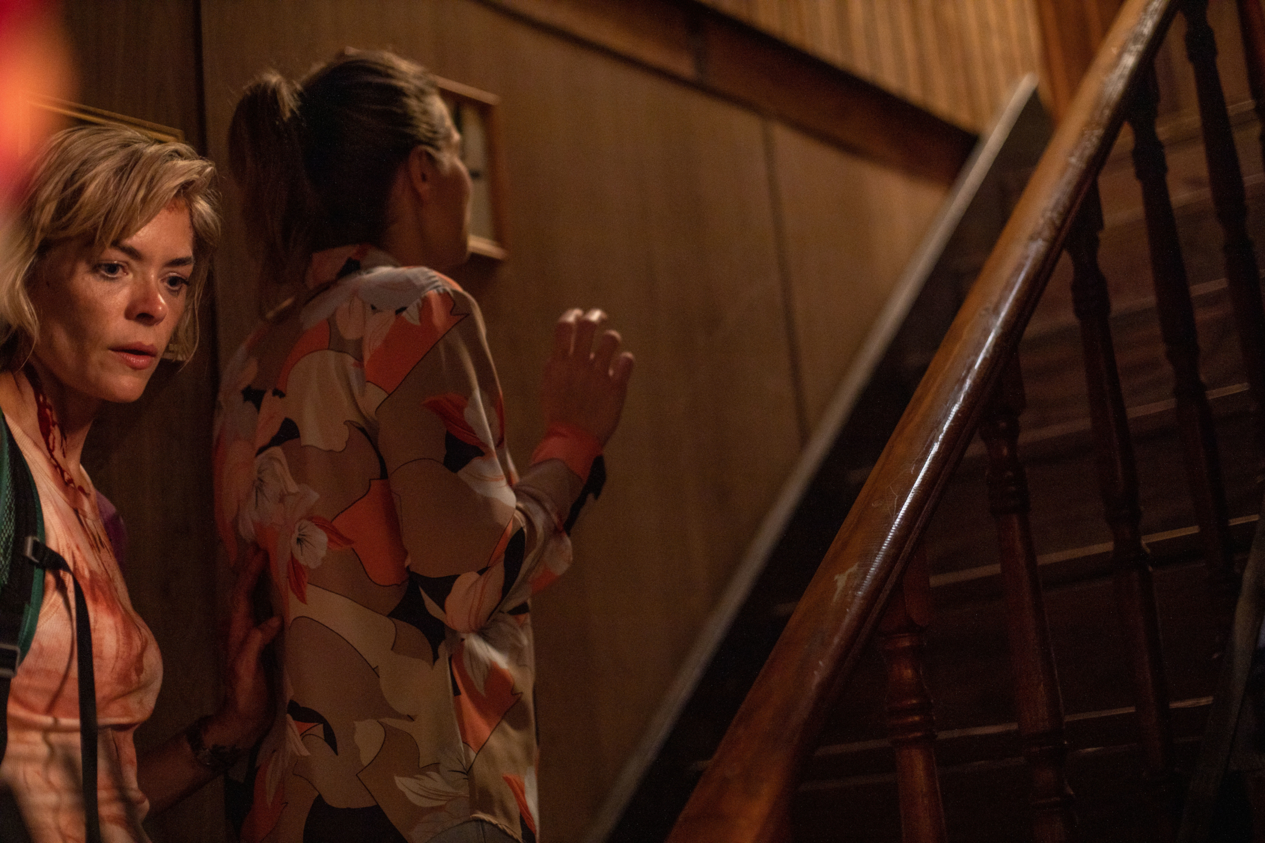 Jaime King and woman on dark staircase in Out Of Death HD Wallpaper