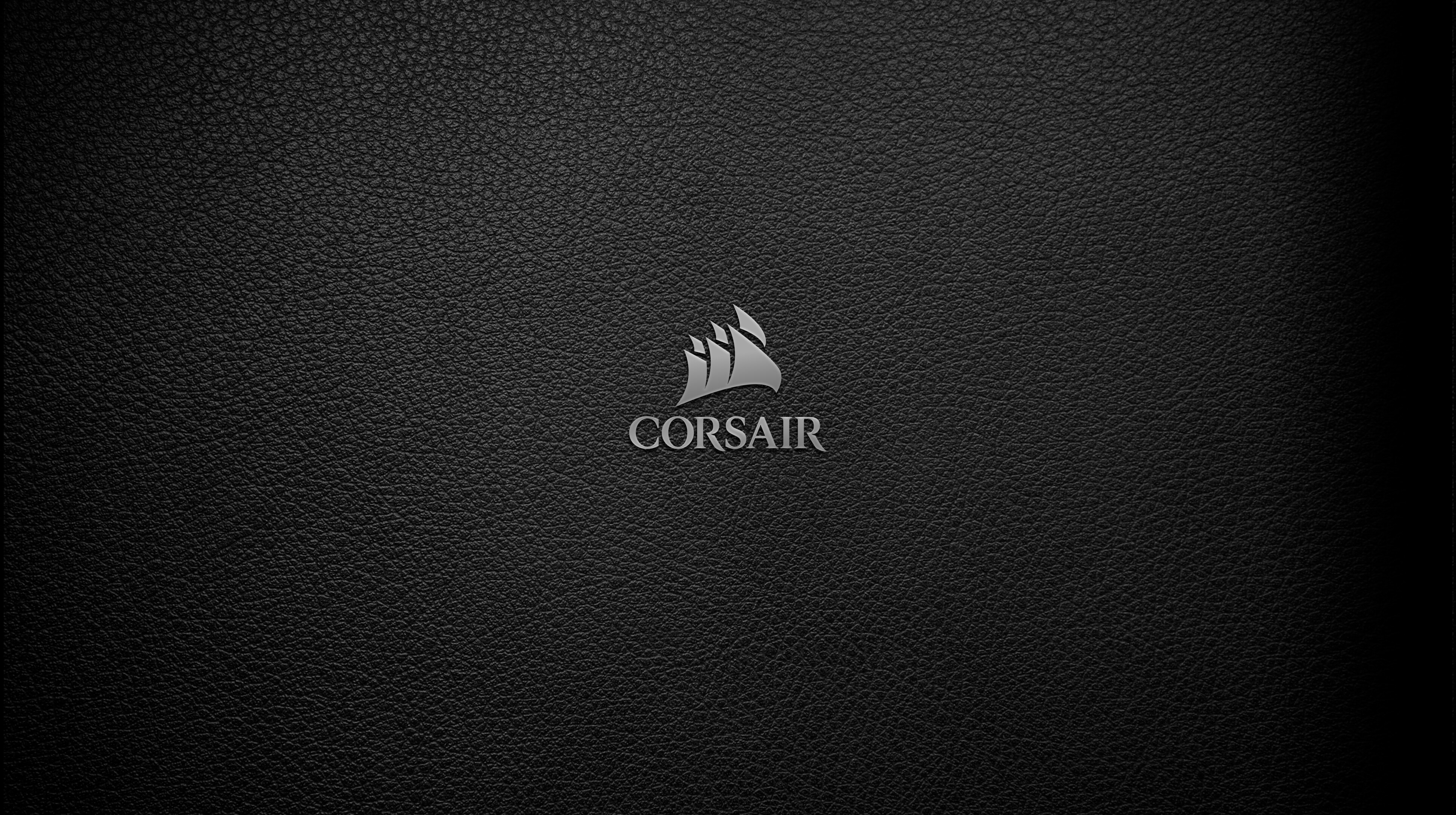 Silver Corsair logo on black leather 4K HD Wallpaper
