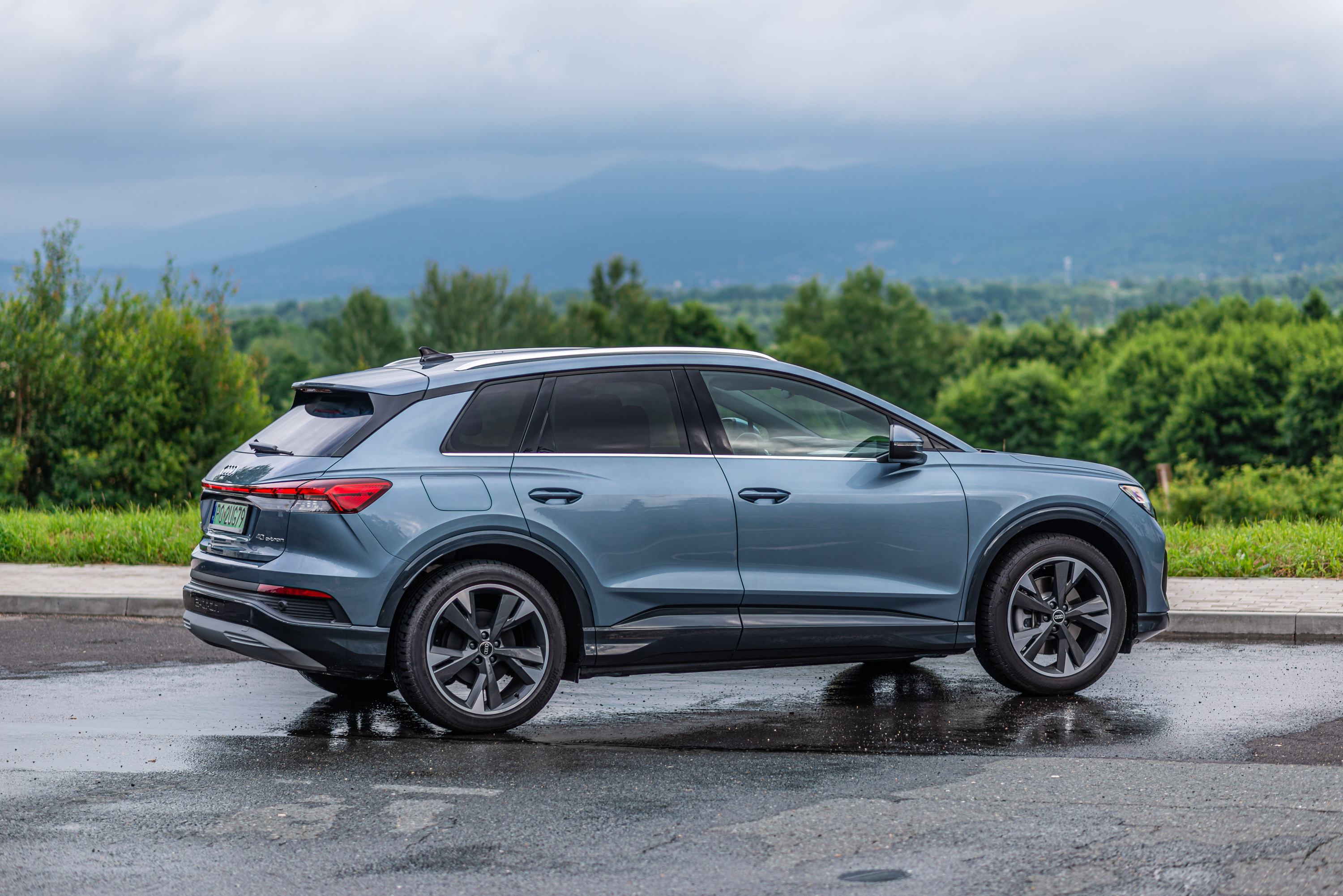 Blue Audi Q4 Electric SUV parked outdoors HD Wallpaper