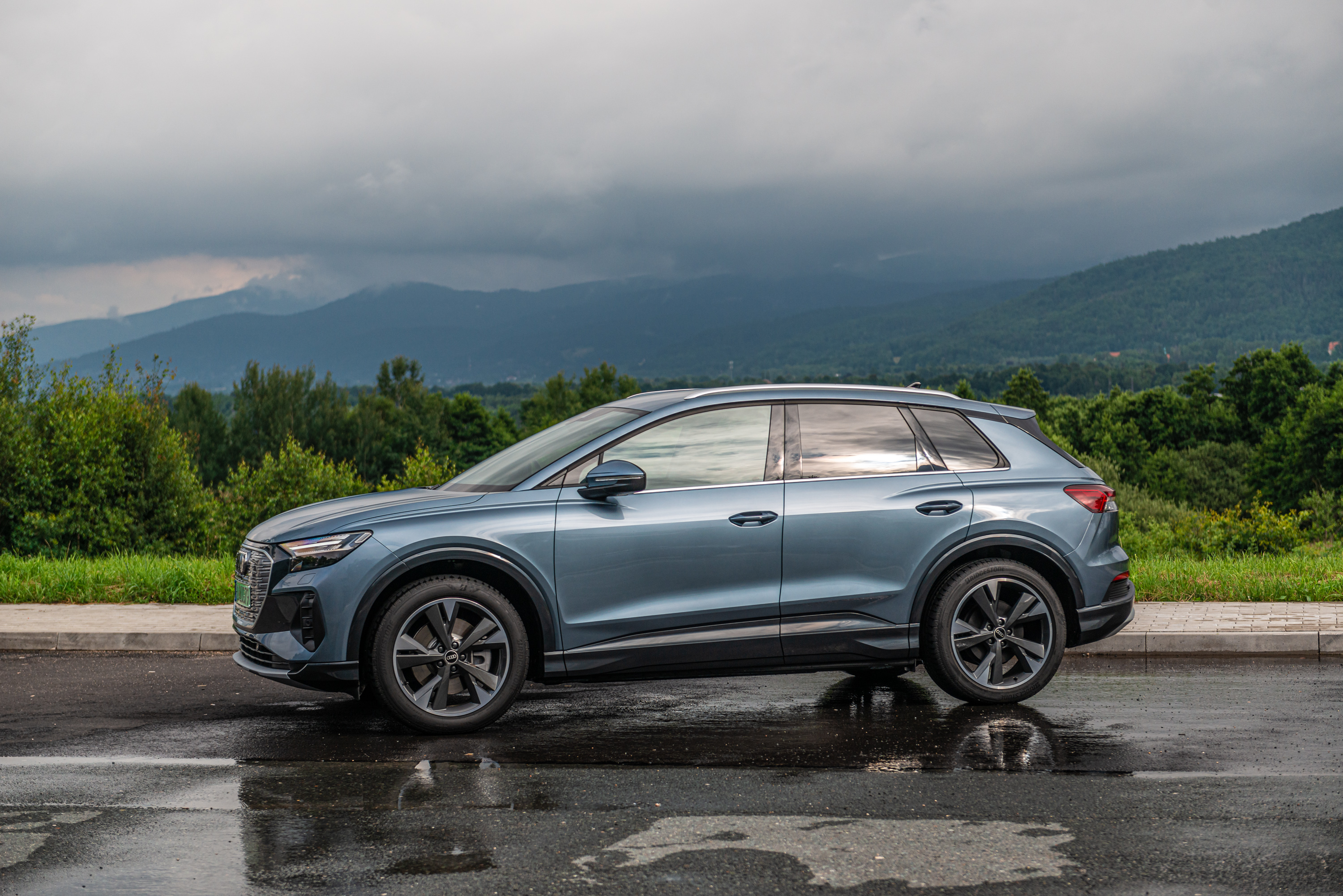 Audi Q4 E-tron electric SUV with mountain view HD Wallpaper