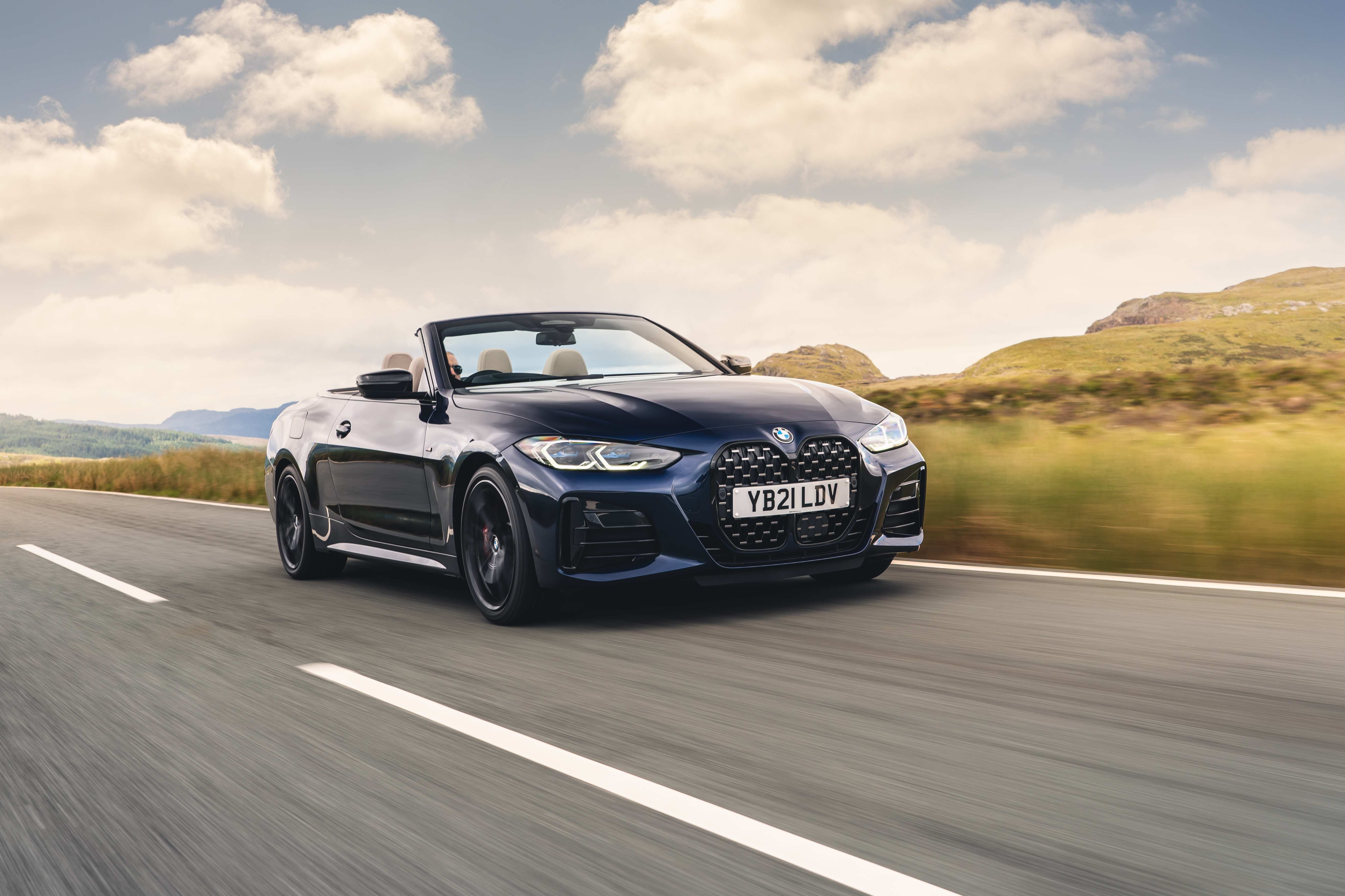 Dark blue BMW M440i Cabriolet on mountain road HD Wallpaper