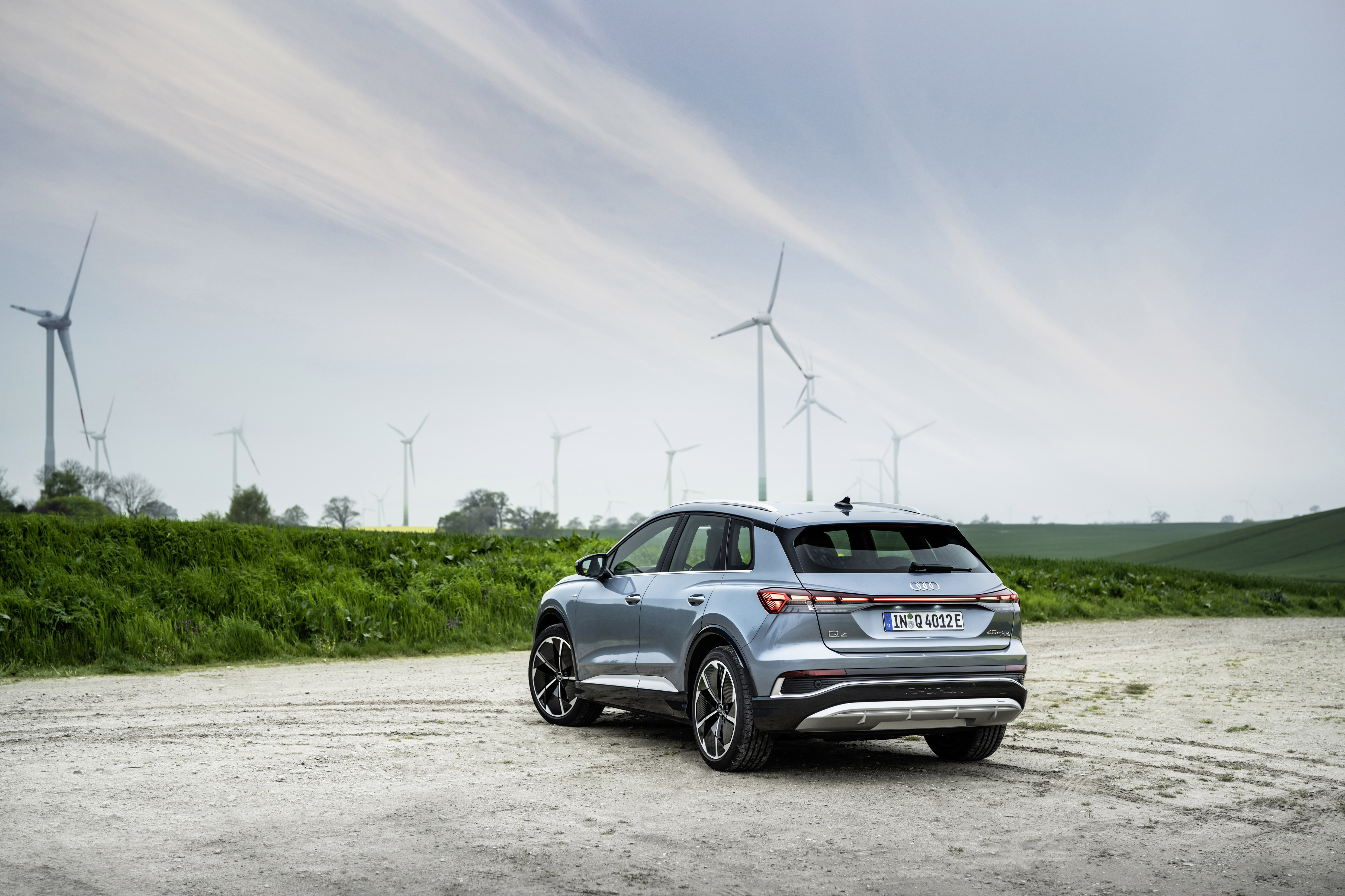 Audi Q4 e-tron electric SUV with wind turbines HD Wallpaper