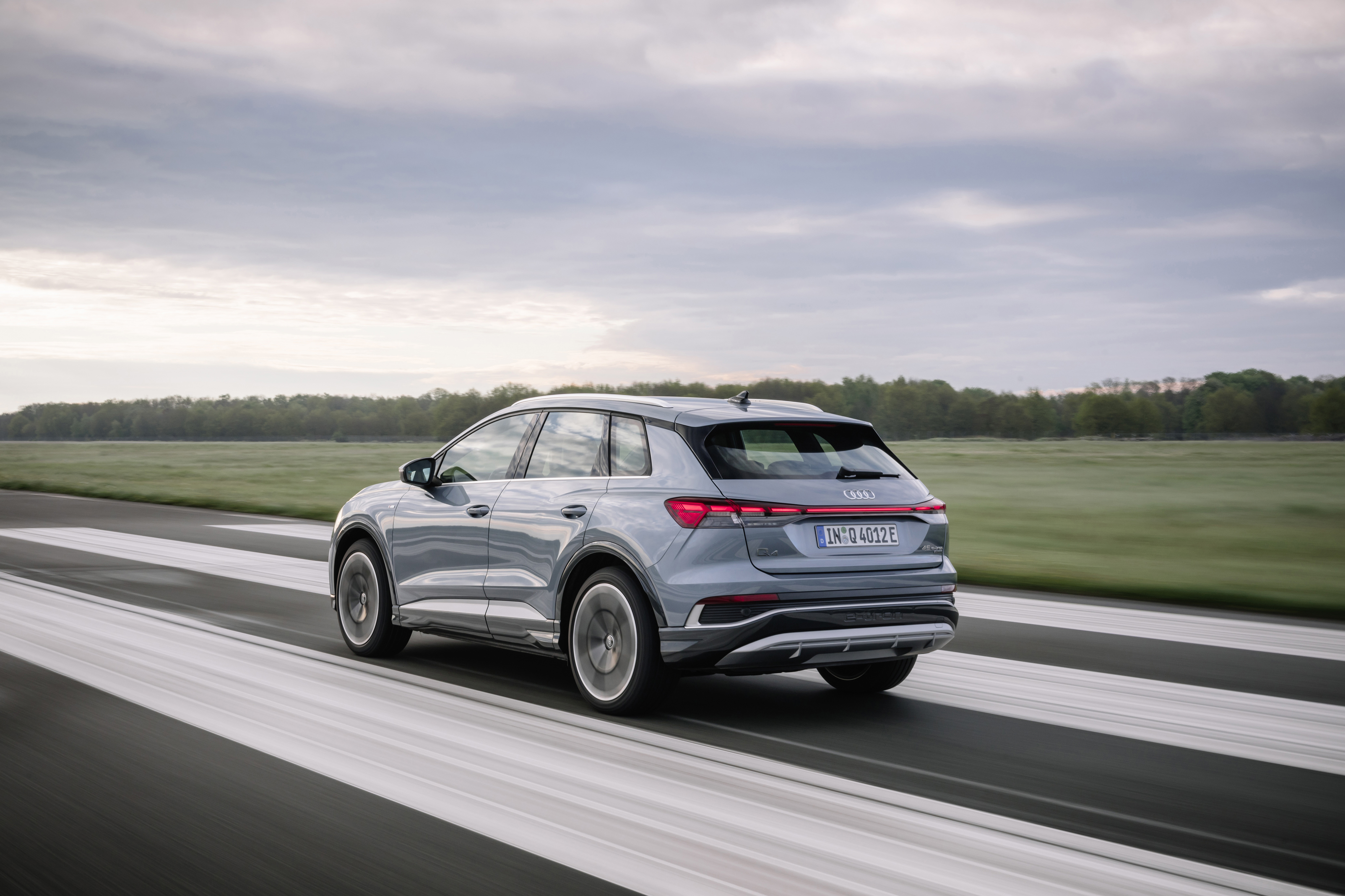 Audi Q4 45 e-tron quattro S line Electric SUV driving HD Wallpaper