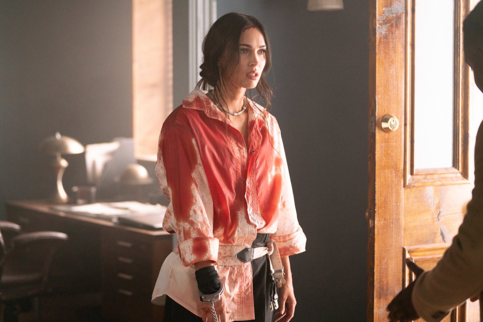 Distressed Megan Fox in bloody shirt and handcuffs HD Wallpaper