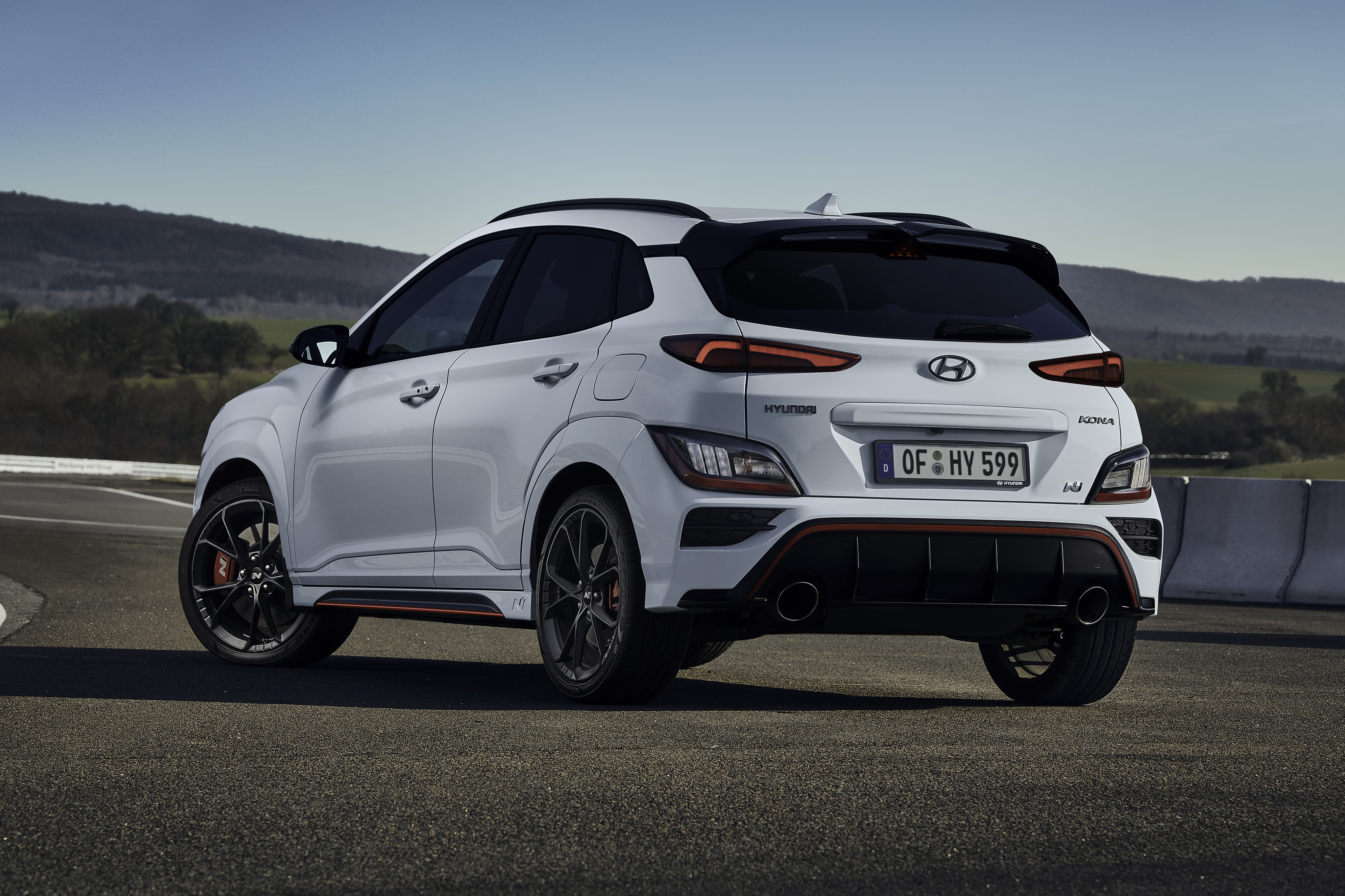 Rear three-quarter view of white Hyundai Kona N SUV HD Wallpaper