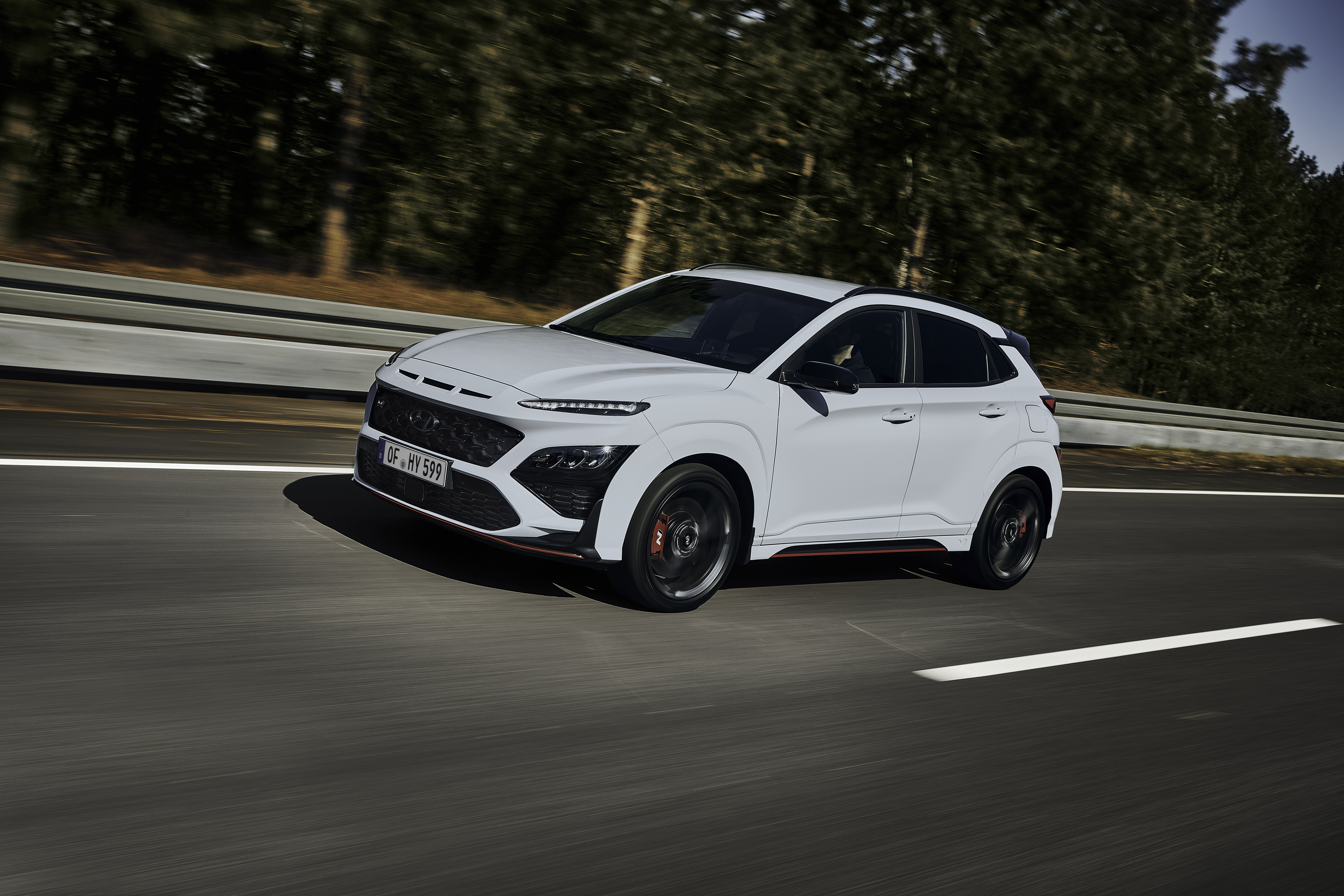 White Hyundai Kona N SUV driving on a road HD Wallpaper
