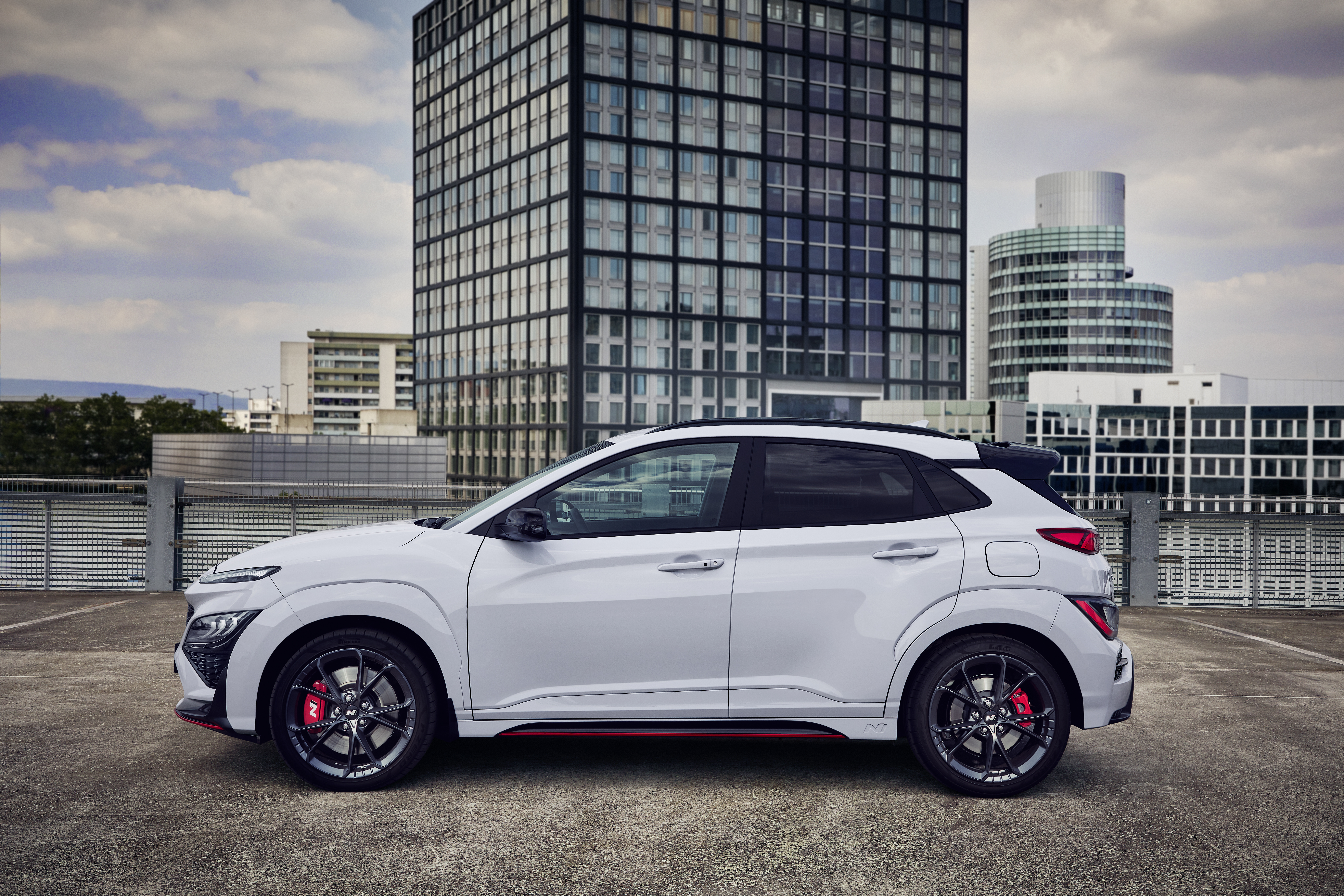 White Hyundai Kona N SUV on city rooftop HD Wallpaper