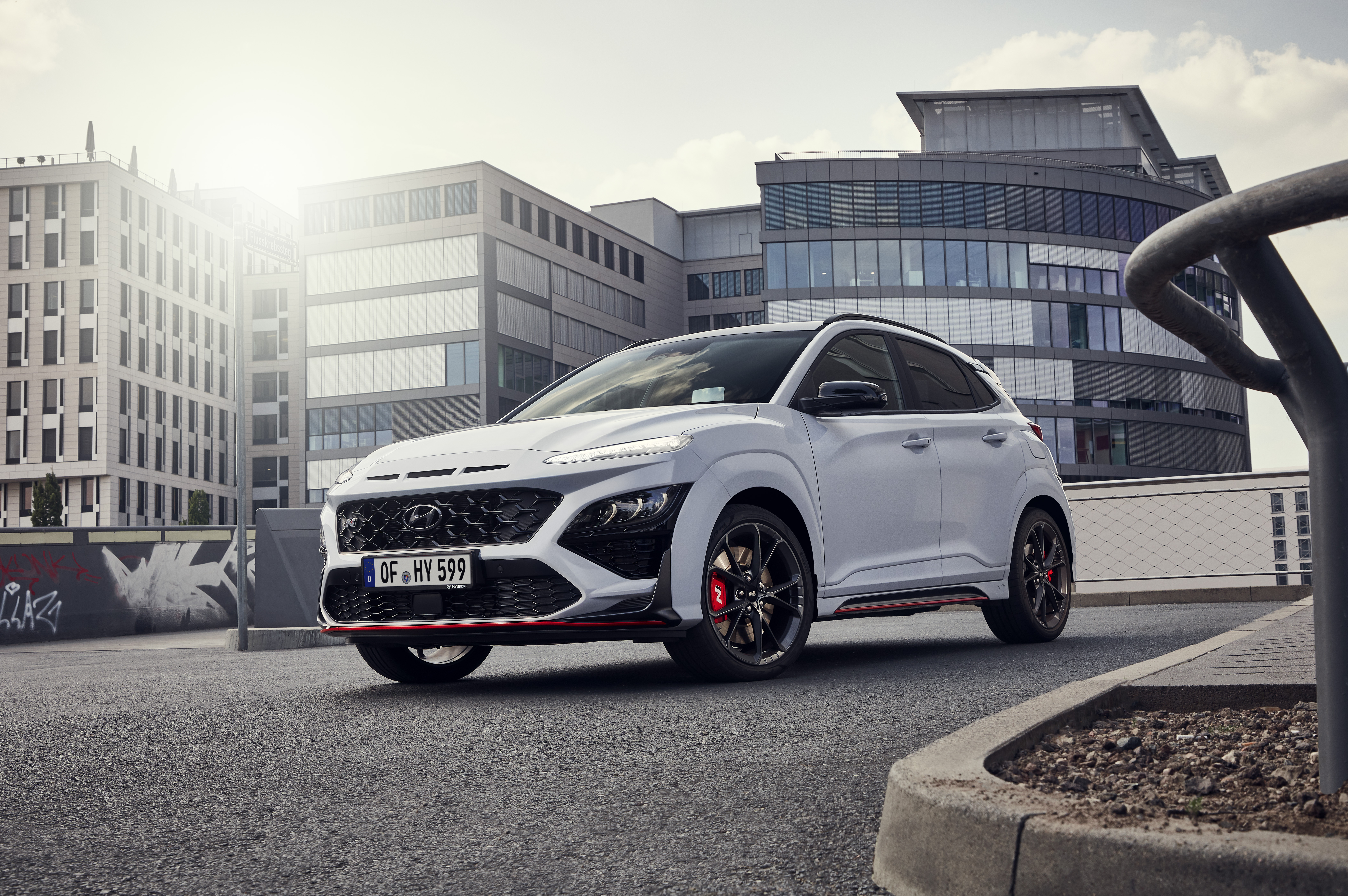 White Hyundai Kona N SUV in a modern urban setting HD Wallpaper