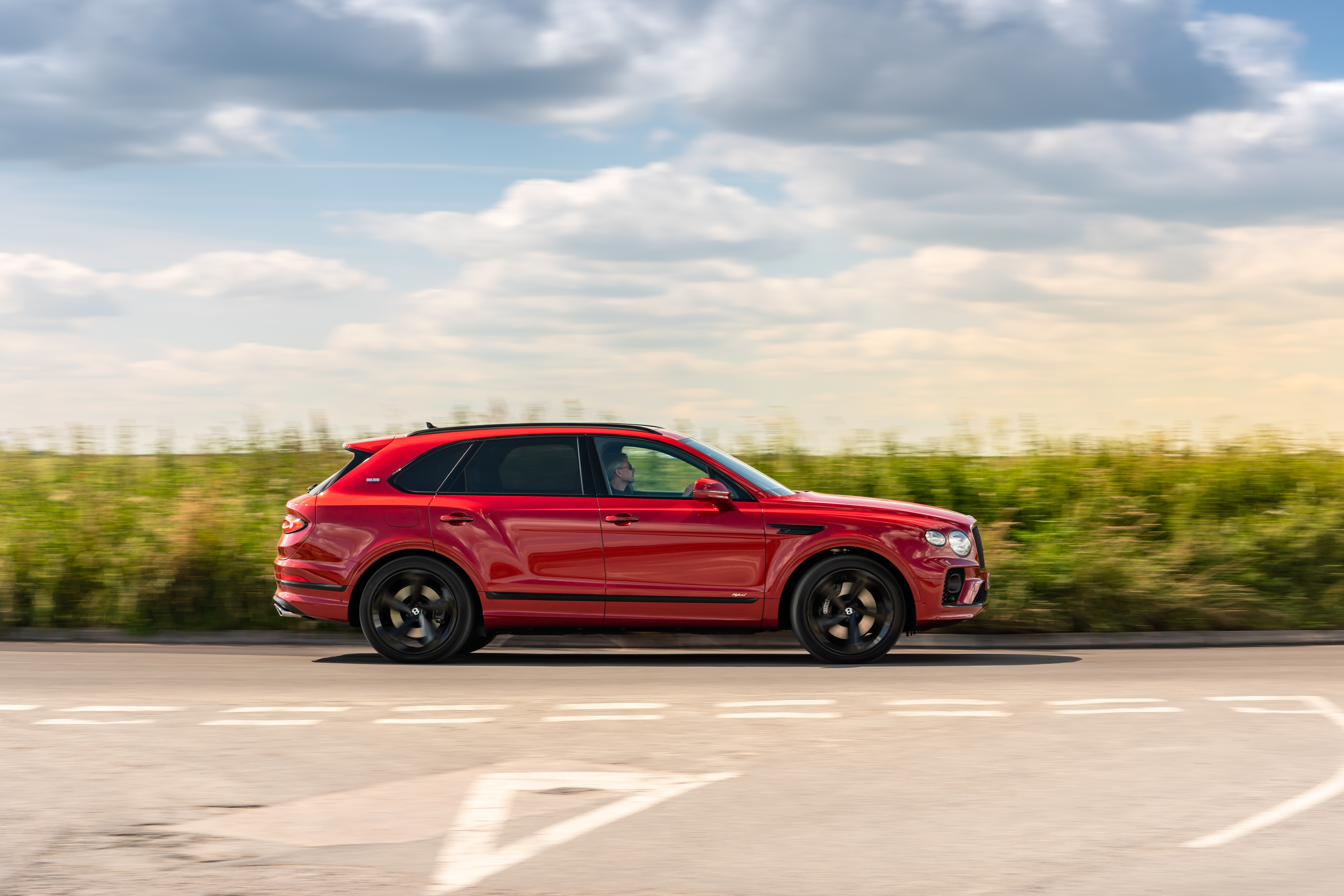 Red Bentley Bentayga Hybrid "First Edition" SUV in motion HD Wallpaper