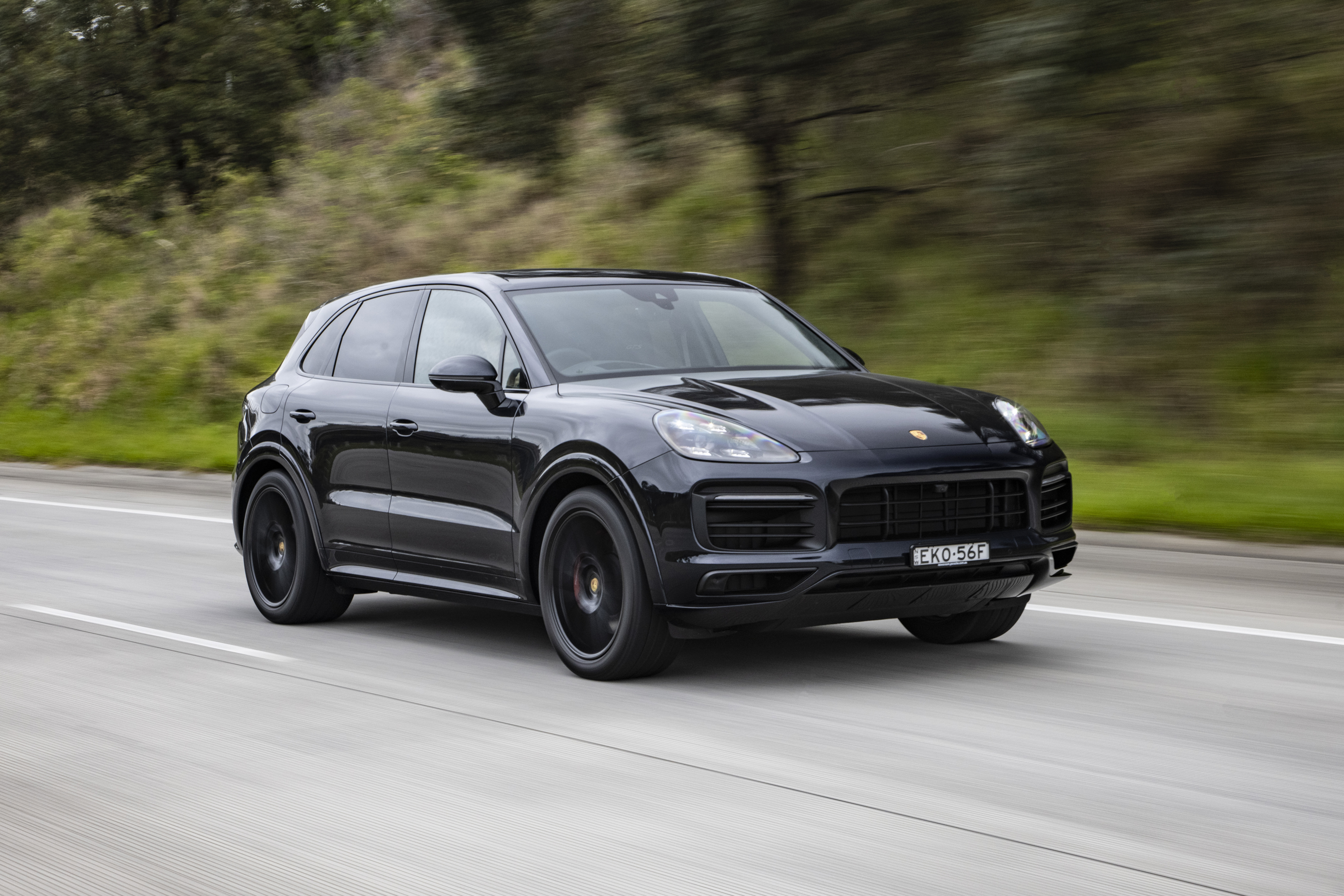 Luxury Black Porsche Cayenne GTS SUV in motion HD Wallpaper