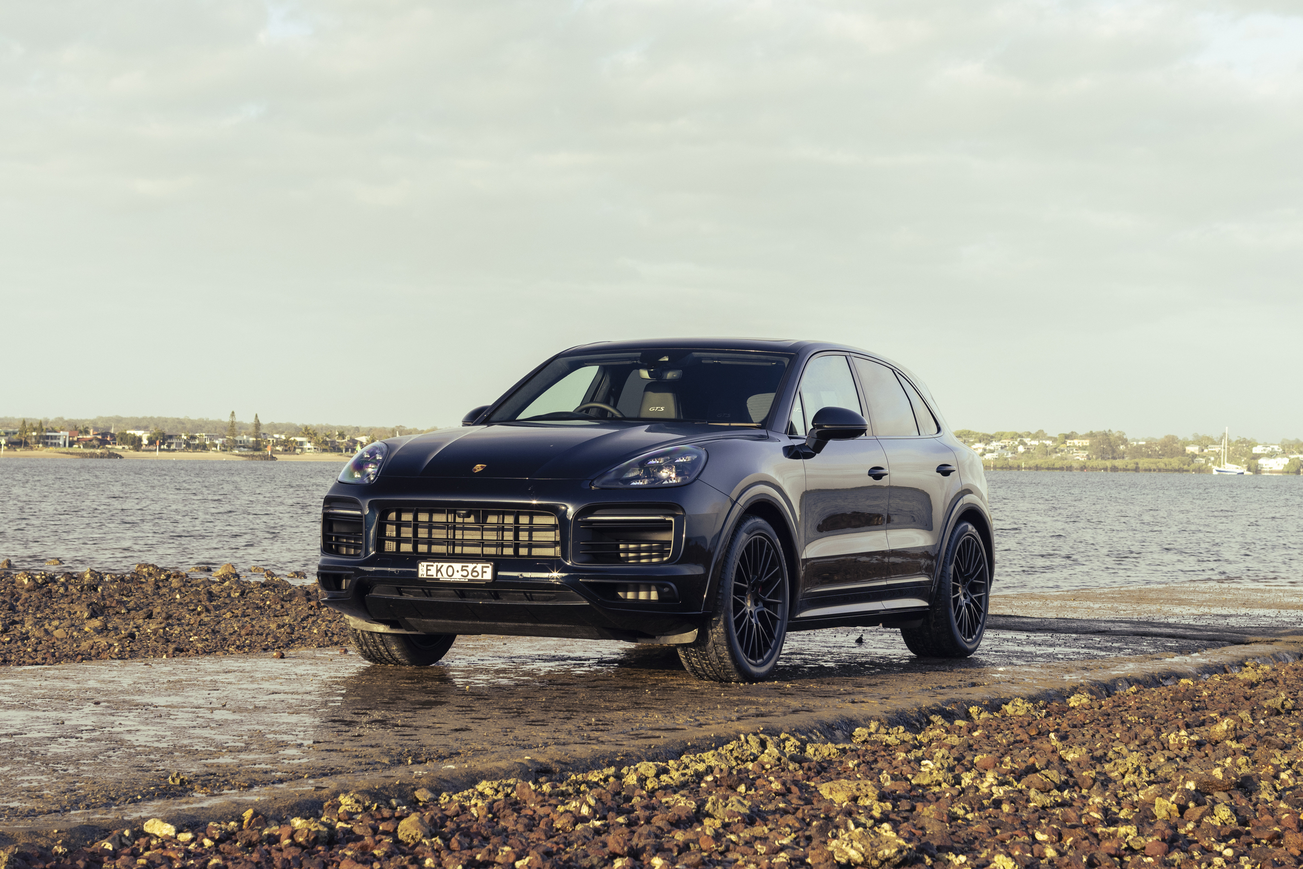 Black Porsche Cayenne GTS SUV by the water HD Wallpaper