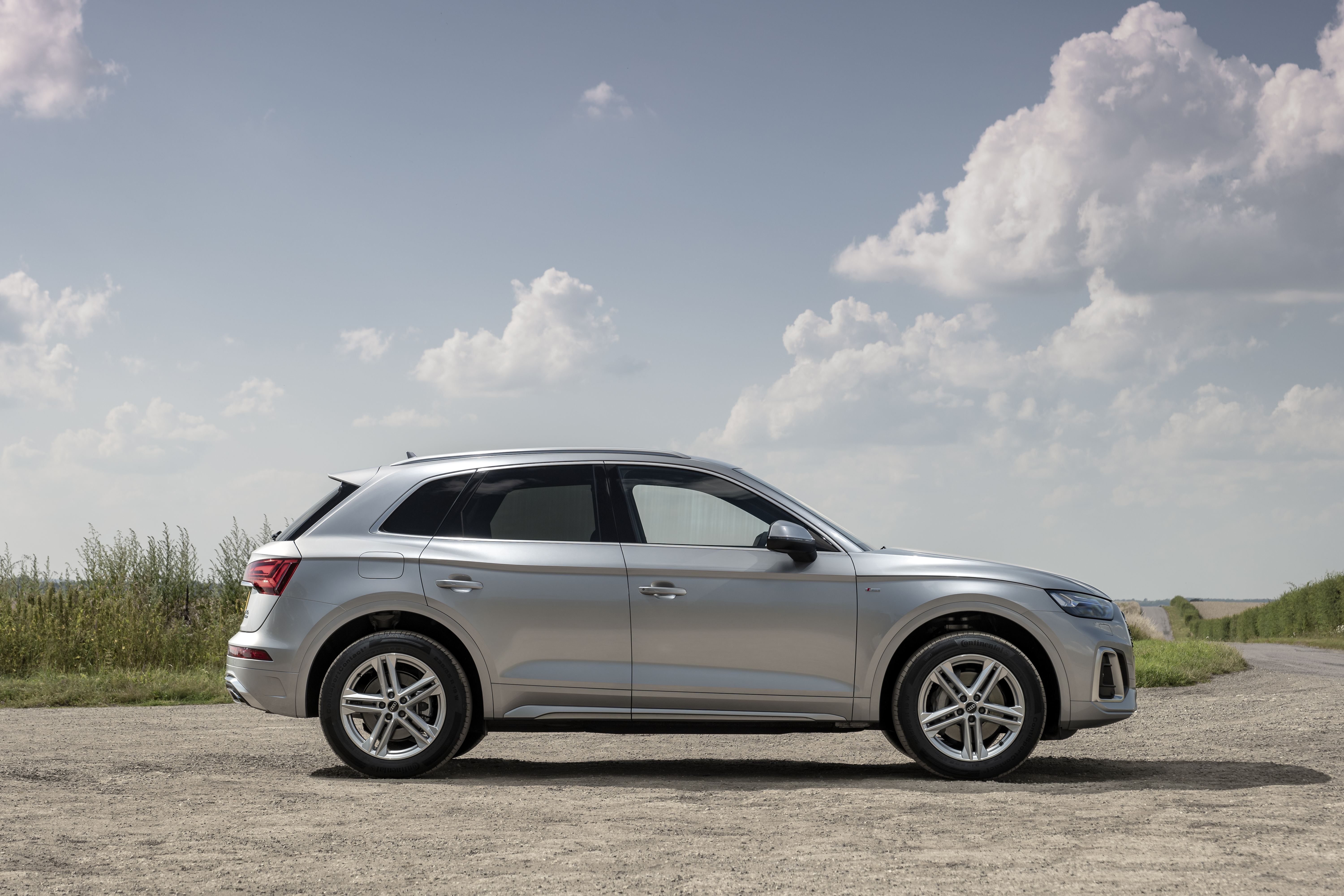 2021 Audi Q4 40 e-tron S line SUV on dirt road HD Wallpaper