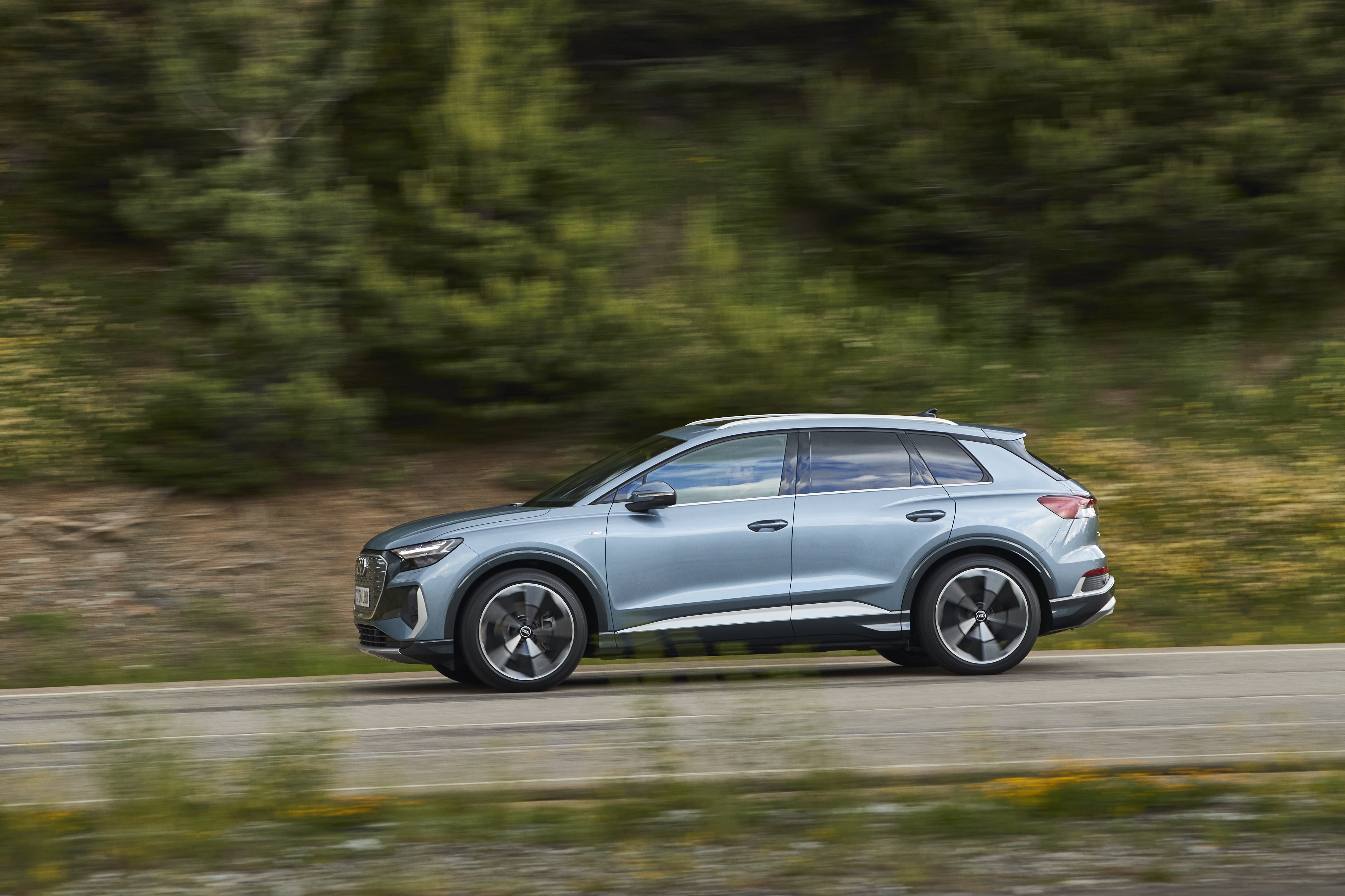 Light blue 2021 Audi Q4 40 e-tron SUV driving HD Wallpaper
