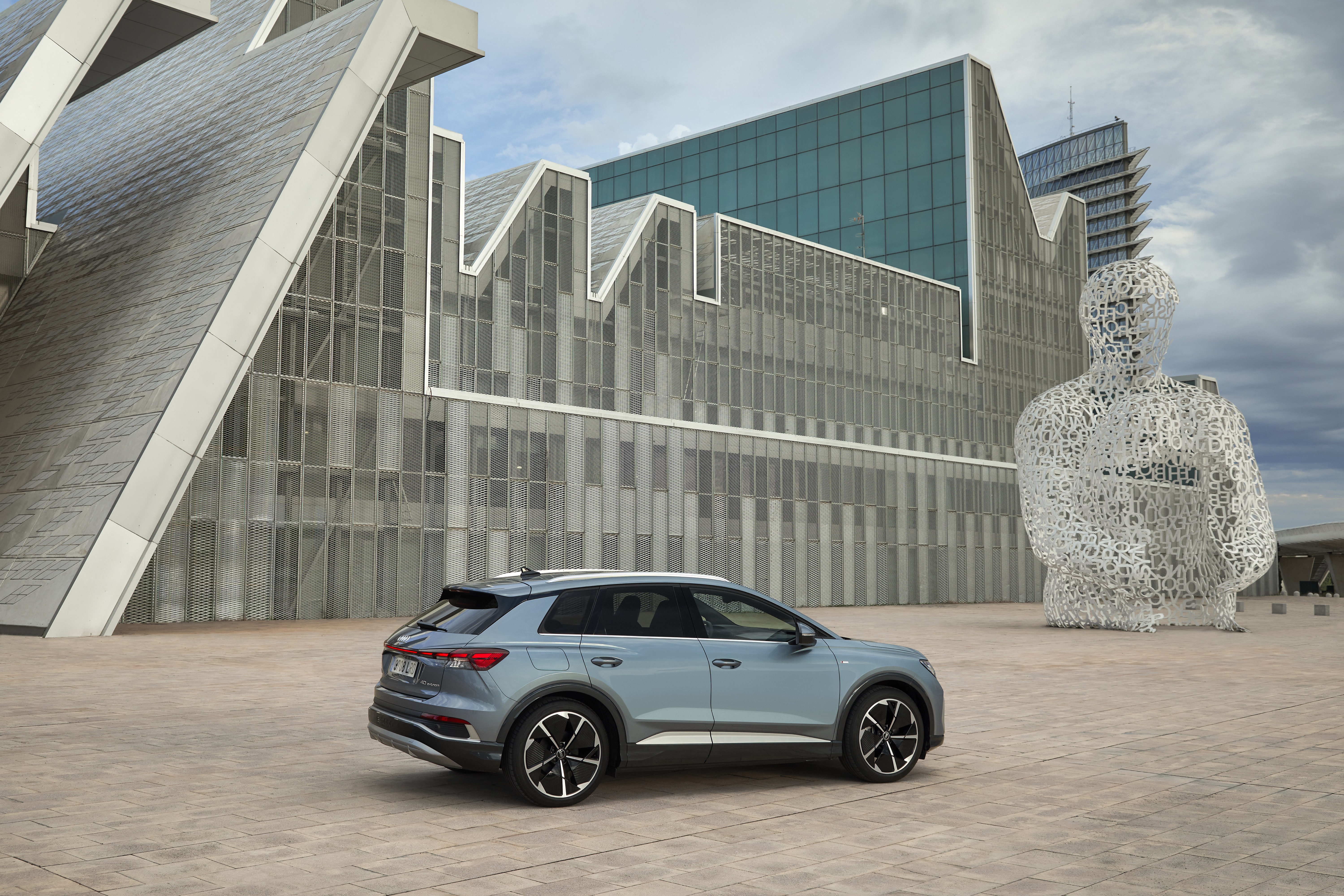 Audi Q4 e-tron SUV with striking modern architecture HD Wallpaper