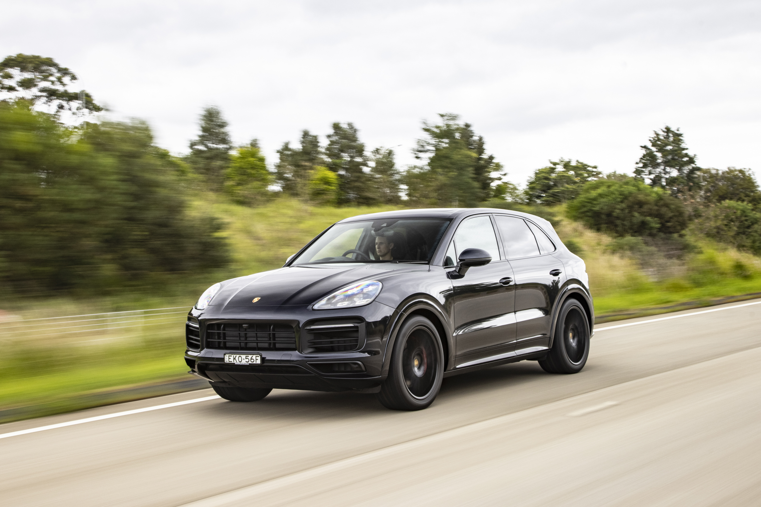 Black Porsche Cayenne GTS SUV driving on road HD Wallpaper