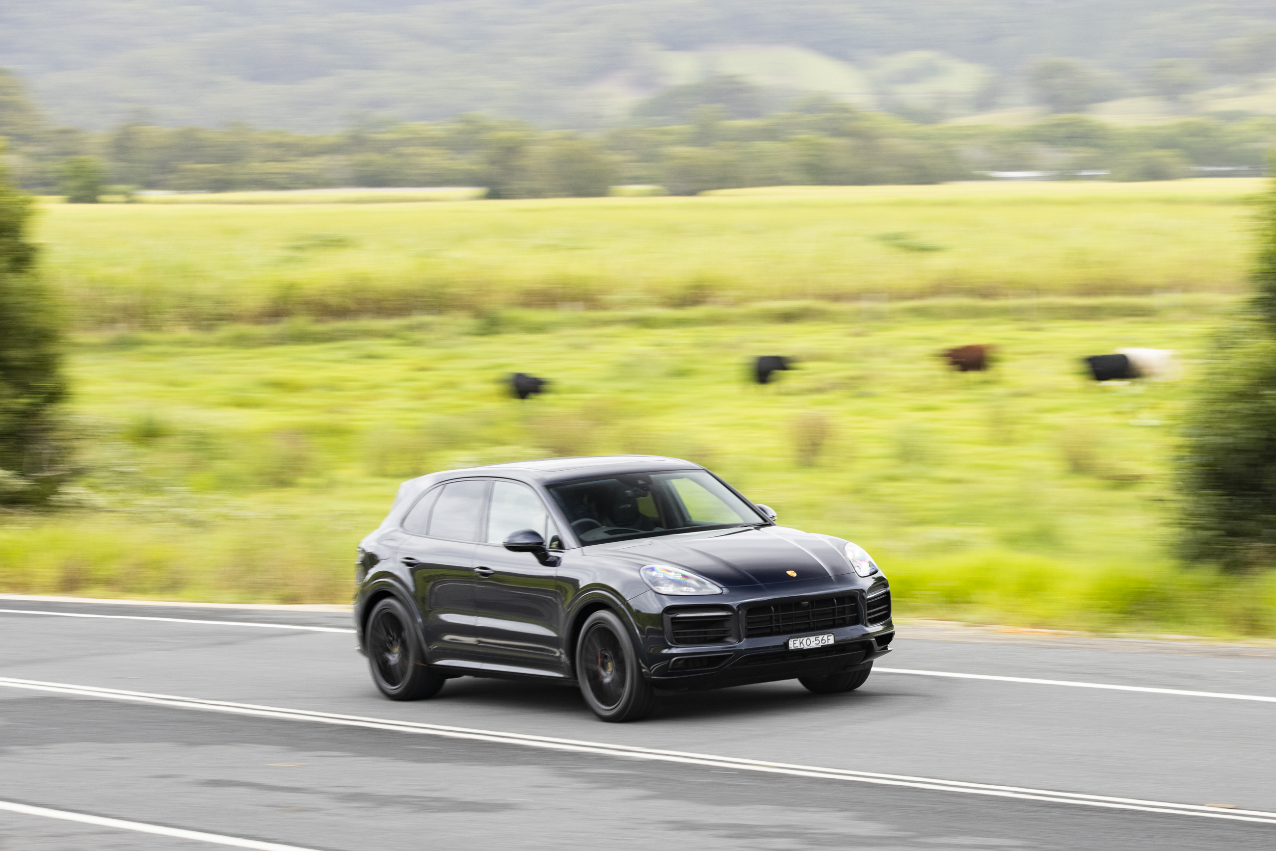 Black Porsche Cayenne GTS SUV driving on a country road HD Wallpaper