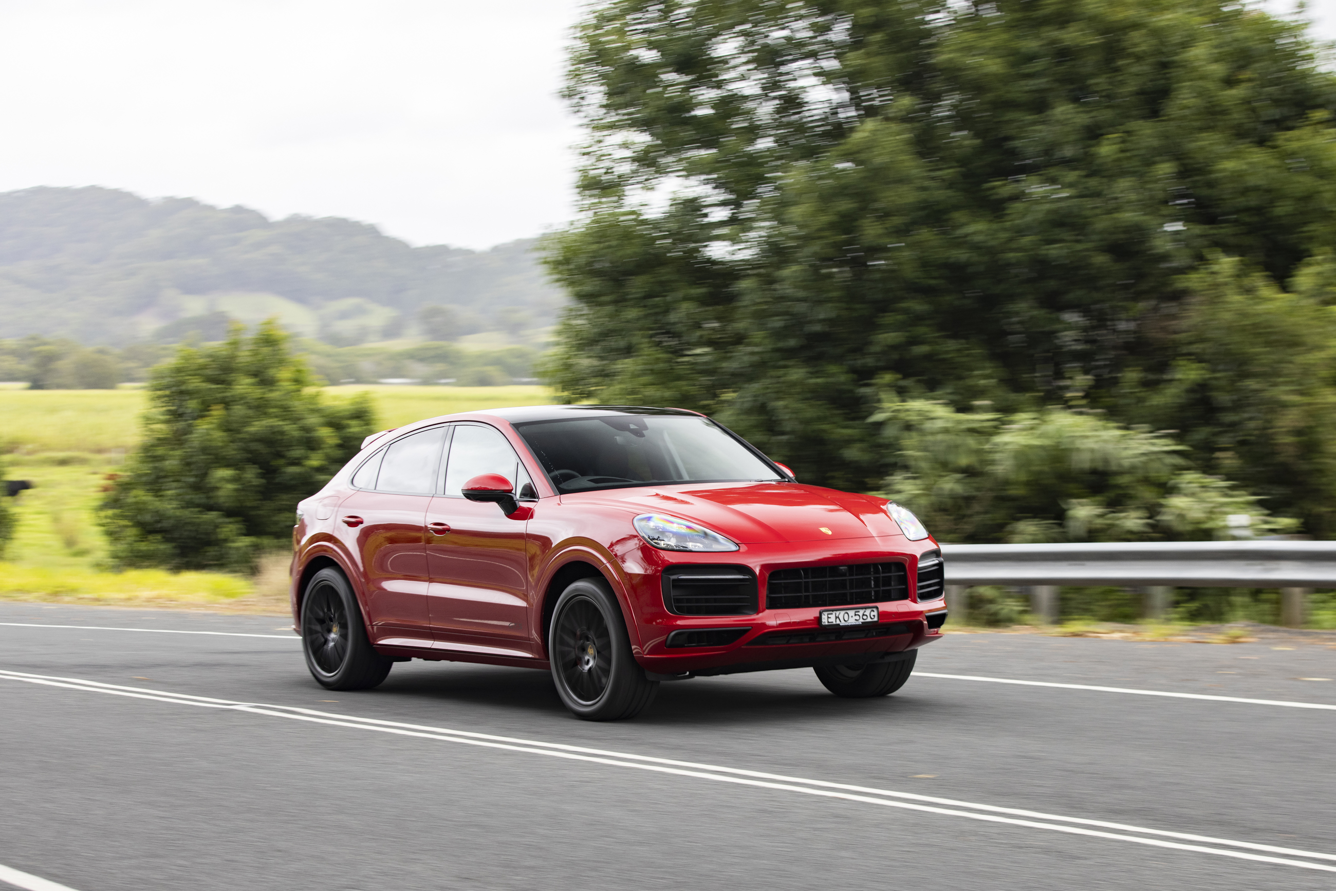 Red Porsche Cayenne GTS Coupé in motion on road HD Wallpaper