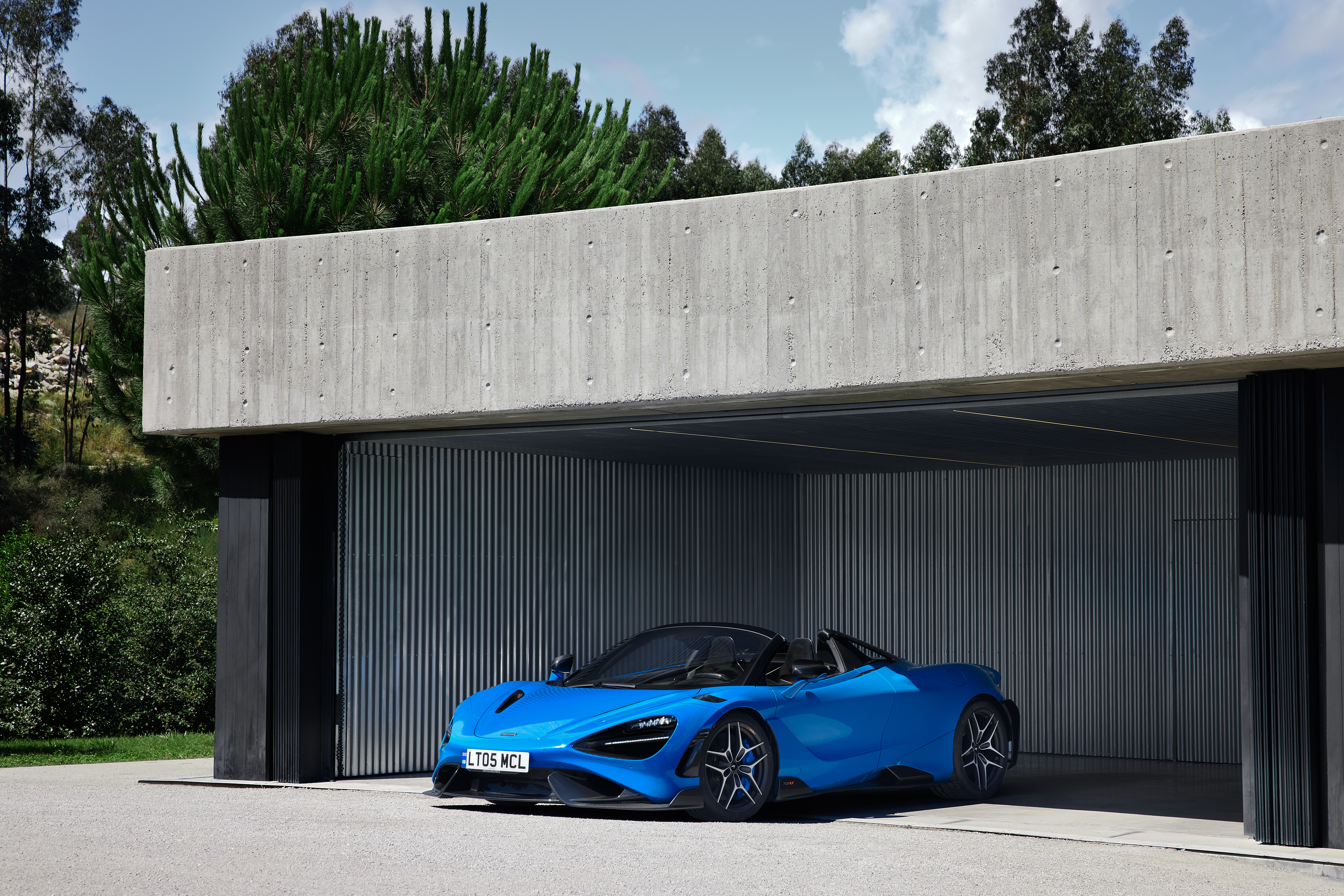 Blue McLaren 765LT Spider in modern concrete garage HD Wallpaper