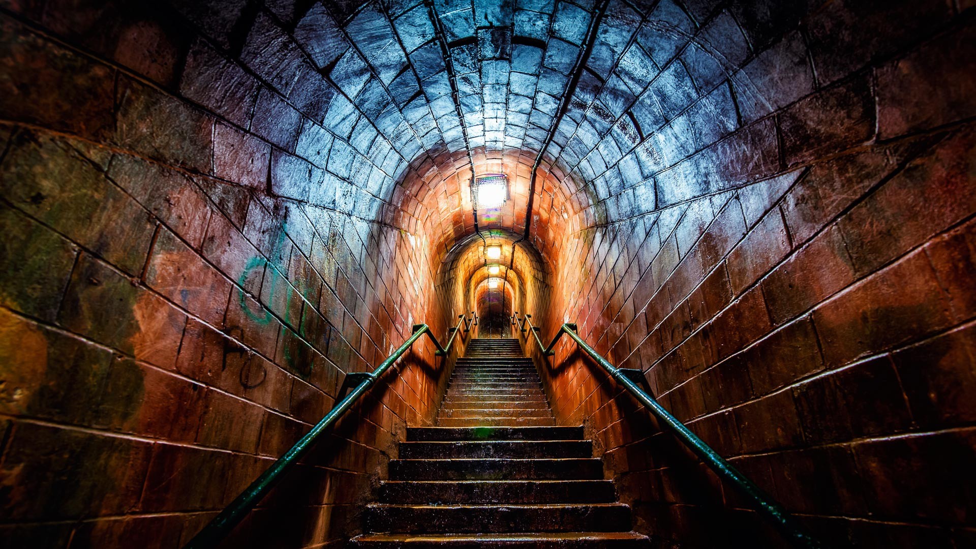 Stairs ascending into a glowing stone tunnel HD Wallpaper