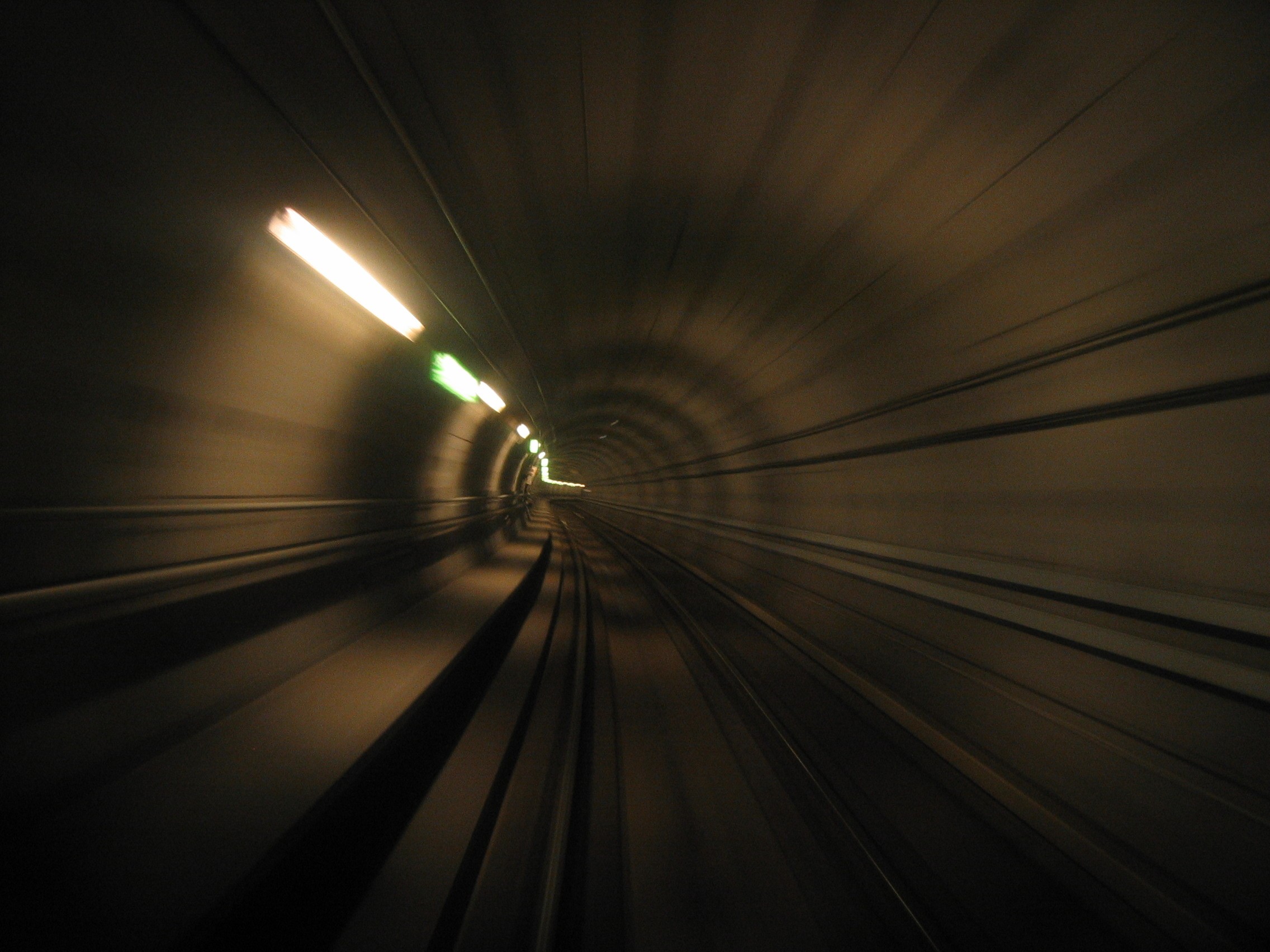 Speeding through a dark tunnel with glowing lights HD Wallpaper