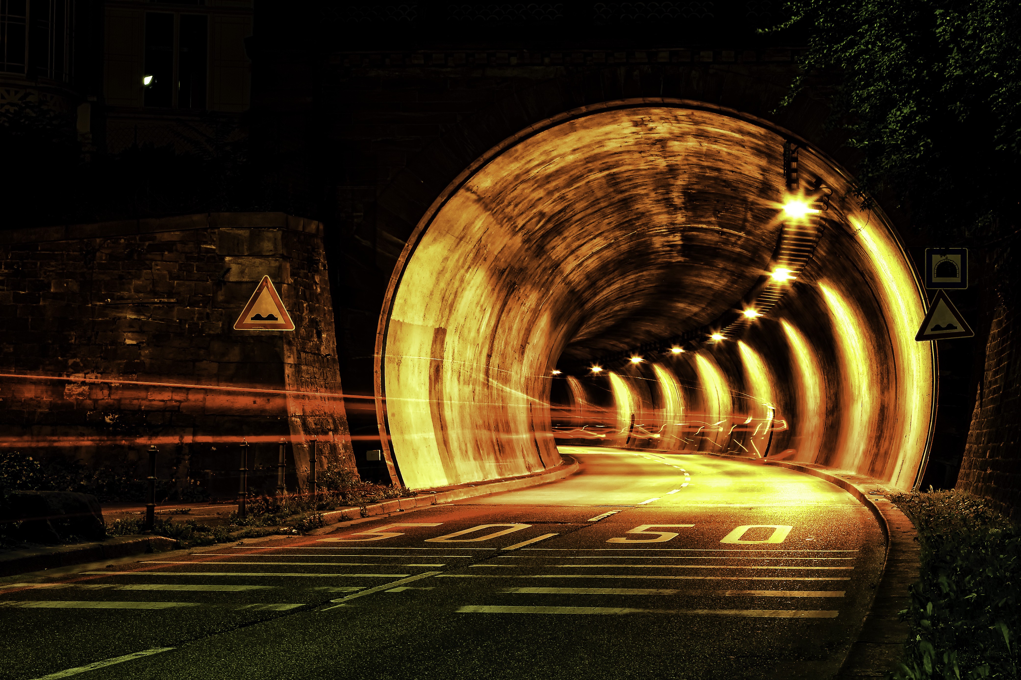Illuminated Night Road Tunnel with Light Trails 4K HD Wallpaper