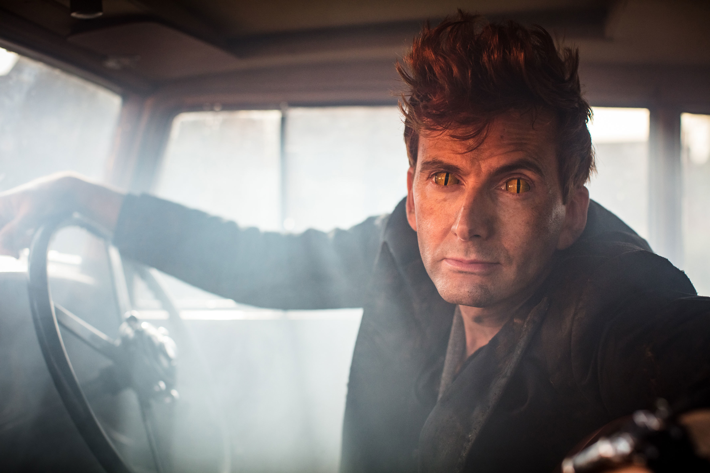 Crowley from Good Omens in Car with Fiery Eyes HD Wallpaper