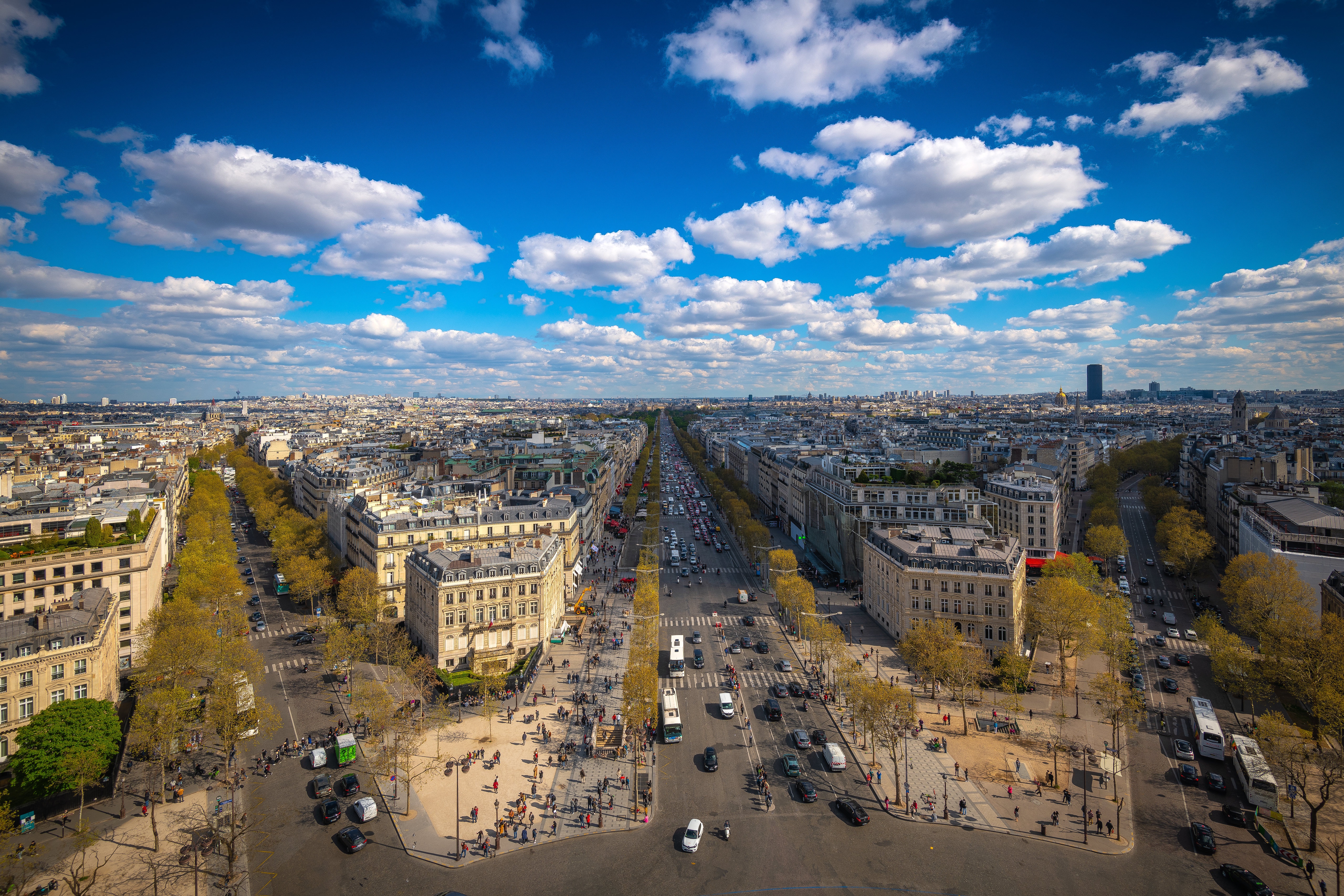Panoramic Paris cityscape with a grand avenue under blue sky HD Wallpaper